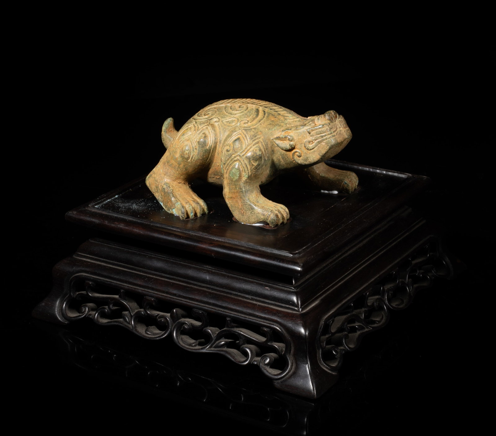 Chinese Bronze Sculpture w/ Wood Base: Cast of mythical beast form, the head turned slightly upward, the body detailed with archaic motif, affixed to a square wood base. Approx. 6.2*6.2*4 inch.
