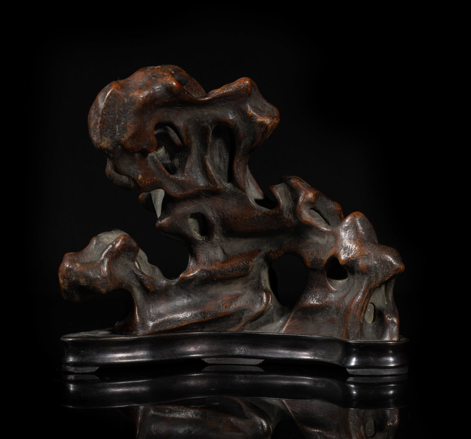 Chinese Bark of Agarwood Table Sculpture: The bark of agarwood sculpture carved of scholar stone form, with wood base. Approx. 5.2*6*1.5 inch (w/ stand).