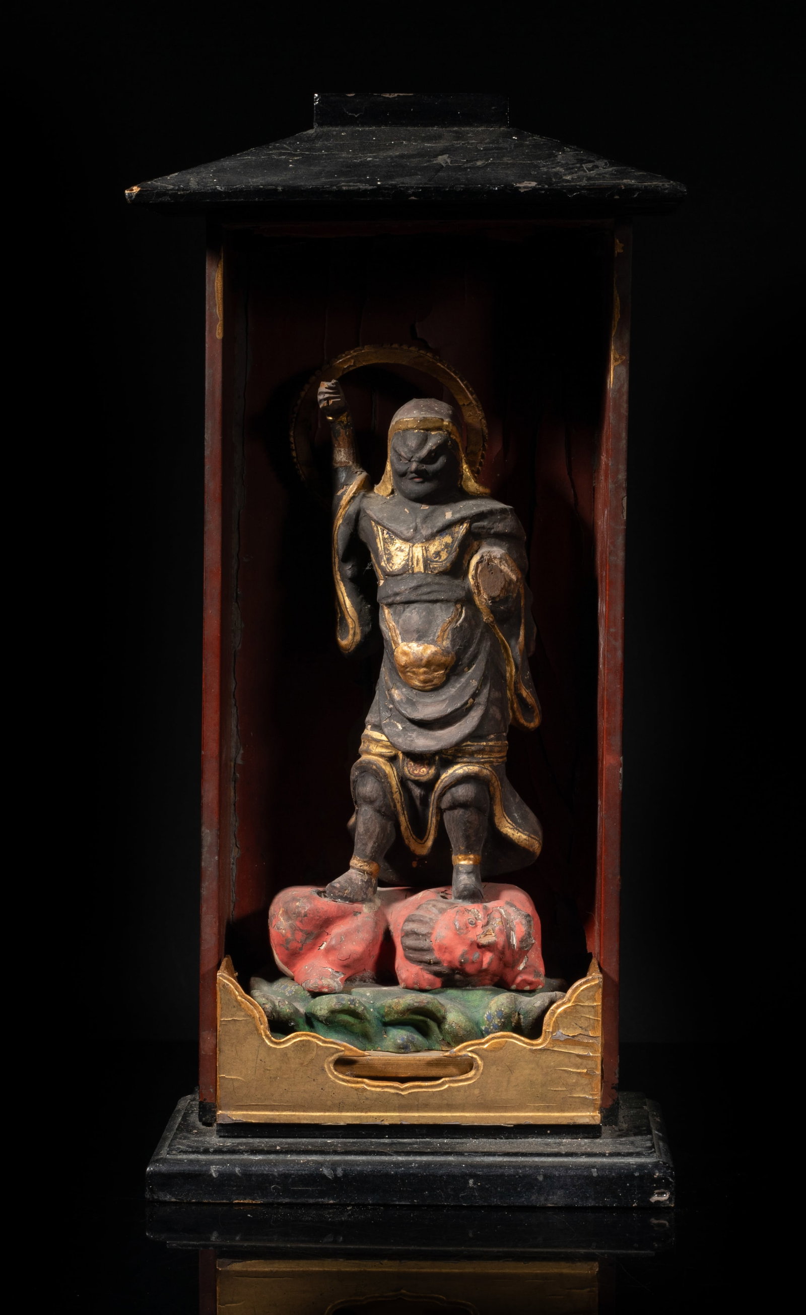 18-19th Japanese Painted Wood Buddha, Ragaraja: Japanese painted wood sculpture of deity Ragaraja standing on a recumbent beast, a circular halo behind his head, with a display case. Approx. 14.7*7.3*4.5 inch.