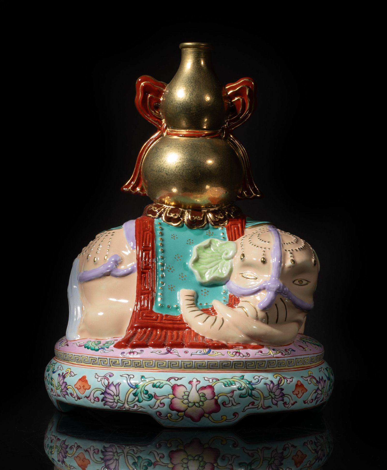 Chinese Famille Rose, Gold Painted Porcelain: Molded as a recumbent elephant supporting a double-gourd shaped vase on its back, the elephant head turned to right, the bottom marked with four characters on turquoise glazed ground. Approx. 7.7*6