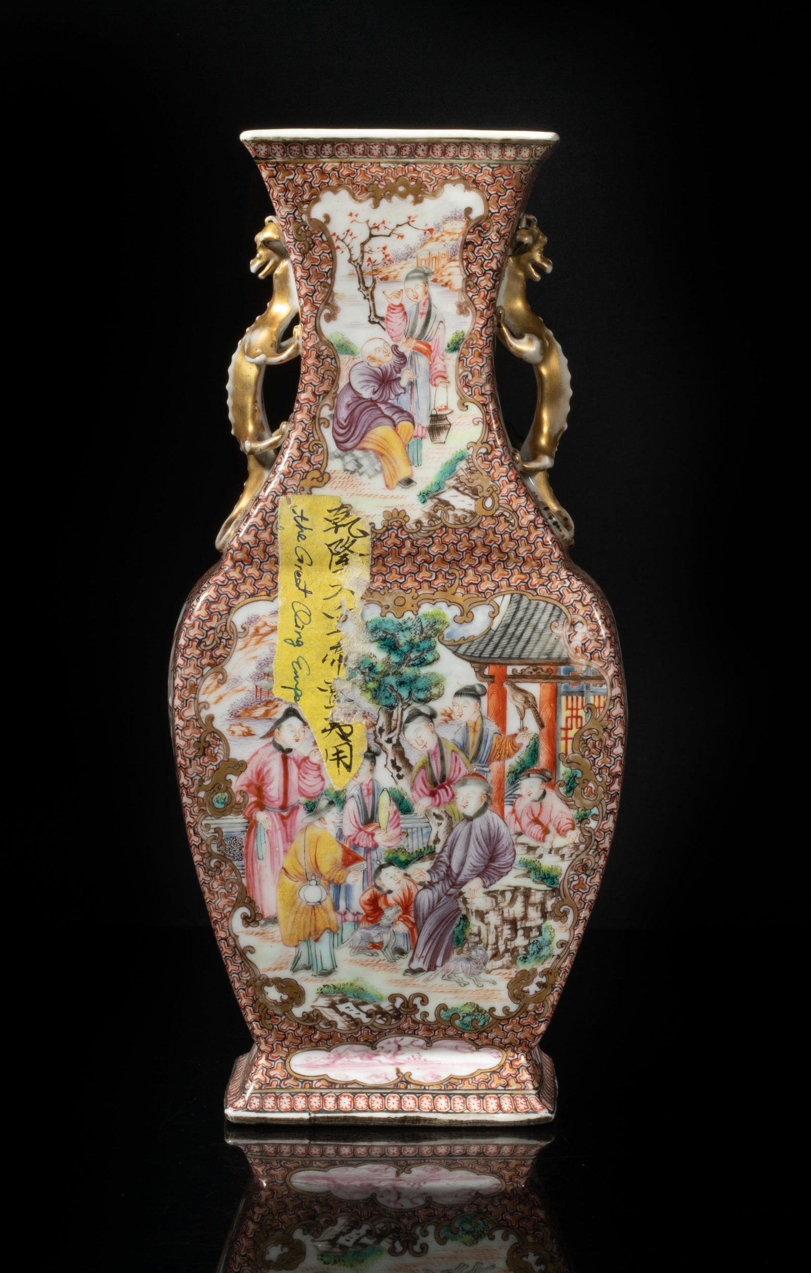 Tall Chinese Export Porcelain Vase: Of rectangular section, the ovoid body rising from a splayed foot to a waisted neck, flanked by a pair of beast handles, each side painted with panels of vivid figural scene, against a ground