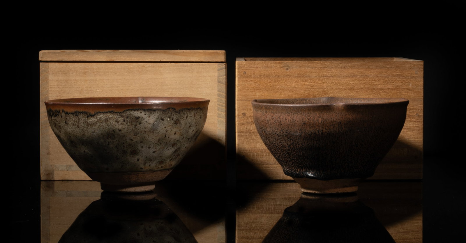 Two Chinese Jian Ware Porcelain Bowls: Each Chinese Jian ware porcelain bowl covered with streaked and mottled brown glaze, stopping above the unglazed foot incised with two characters, with cases. Approx. 5.07*2.7 inch (larger bowl).