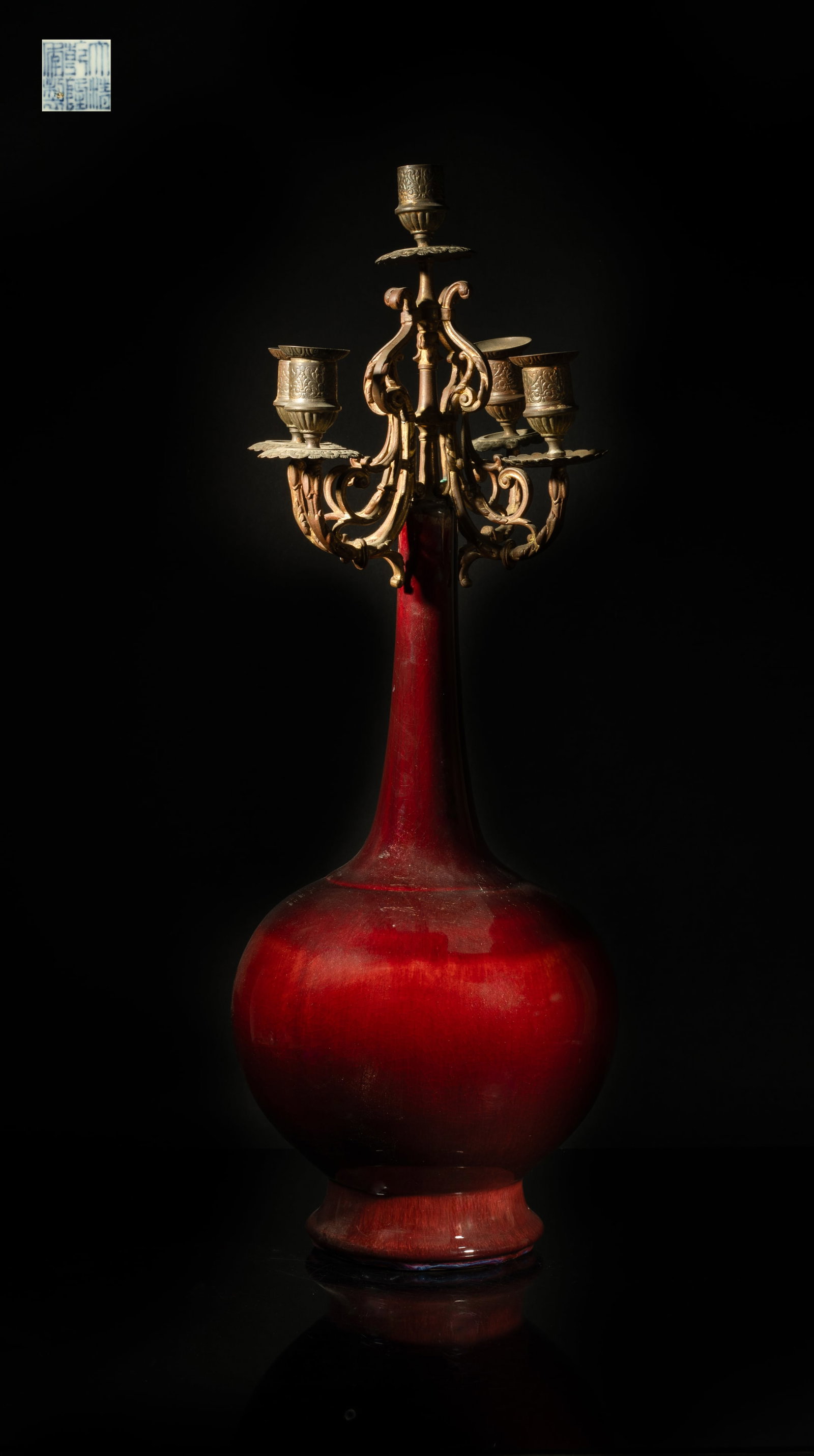 Tall Chinese Export Porcelain Candlesticks: The ovoid body rising from a splayed foot to a tall slender neck, the body applied with crackled dark-red glaze, the bottom with a six-character mark, surmounted with metal cast 5-piece candlestick