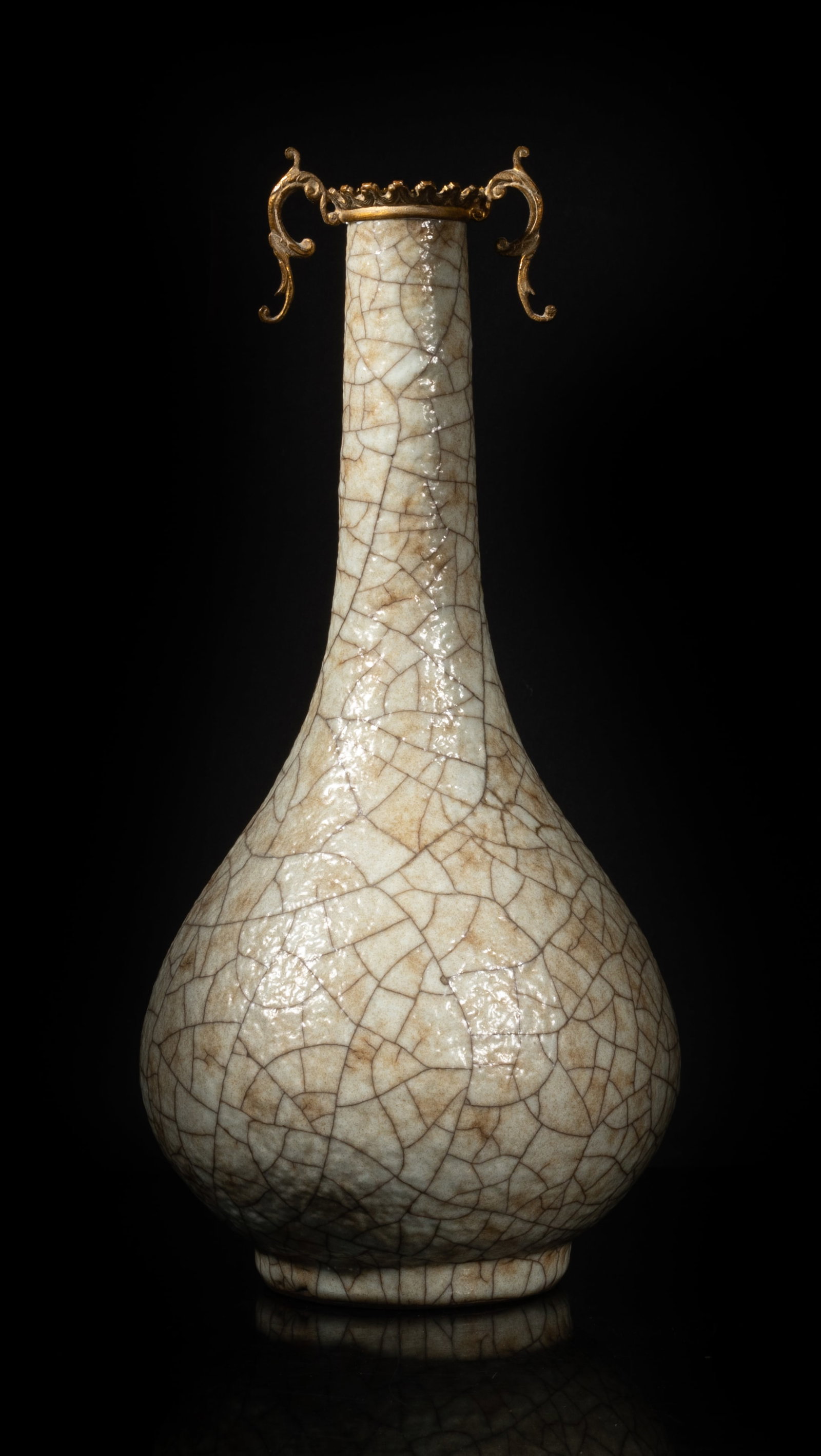 Chinese Export Crackle Glazed Porcelain Vase: The pear-shaped body rising from a short foot to a tall slender neck, overall covered in mottled gray glaze suffused with a matrix of black crackles, with metal rim and handles. Approx. 11.7*5.5 inch.