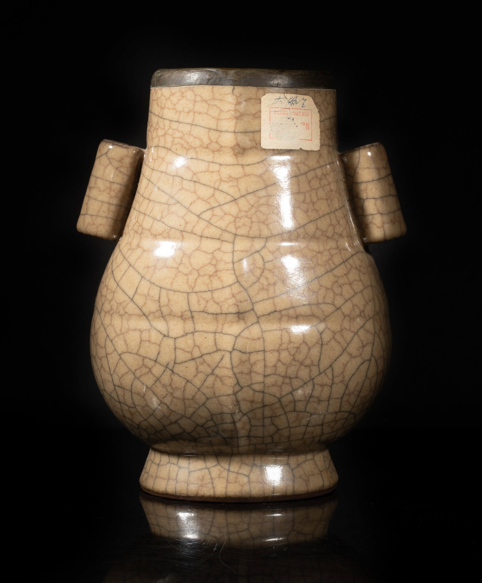 Estate Chinese Crackle Glazed Porcelain Vase: The bulbous body flanked by two tubular handles, with a splayed foot, overall covered in soft-brown glaze suffused with a matrix of black and brown crackles. Approx. 7.2*5.7*4.2 inch.