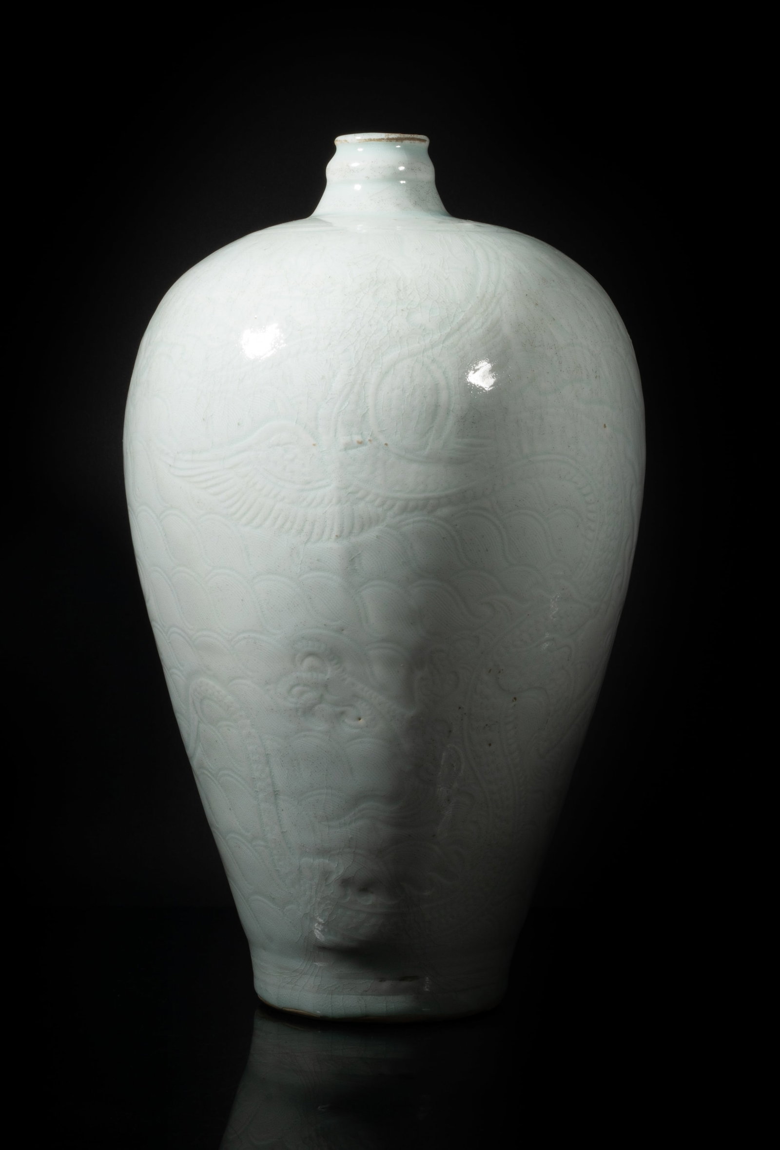 Tall Chinese Hutian Porcelain Vase: Of tall baluster form, the exterior carved in low relief with two sinuous dragons over waves, covered with crackled greenish white glaze. Approx. 12.8*7.5 inch.