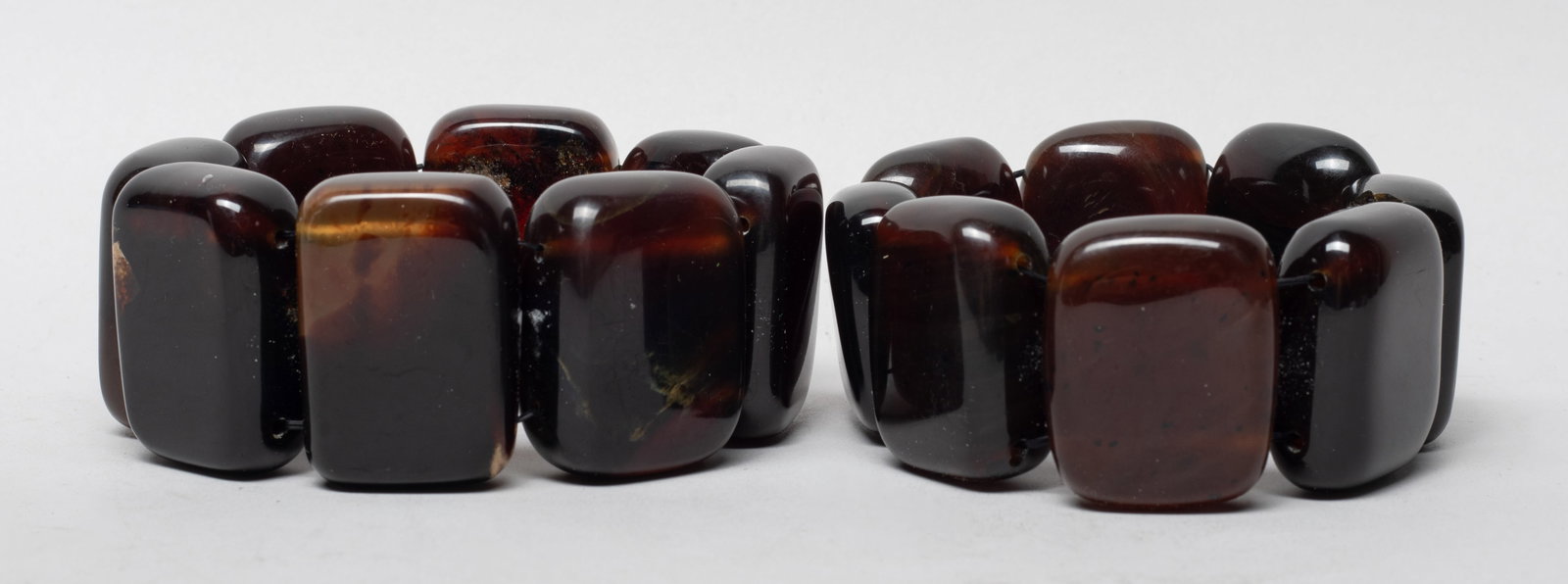 Estate Large Dish Beads Root Amber Bracelets: Two root amber carved dish bead bracelets. Approx. 215 gram (total amber weight), 1.5*1.2 inch (largest bead size).
