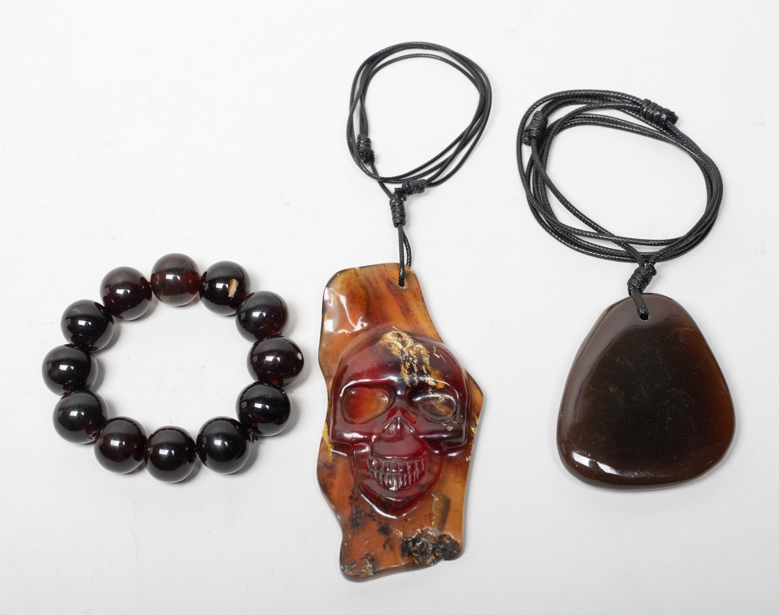 Root Amber Prayer Beads, Slab Pendants: Including a bead bracelet, and two slab pendants with necklaces, wherein one pendant carved with skull. Approx. 160 gram (total amber weight), 4.7*2.5*0.6 inch (larger pendant).