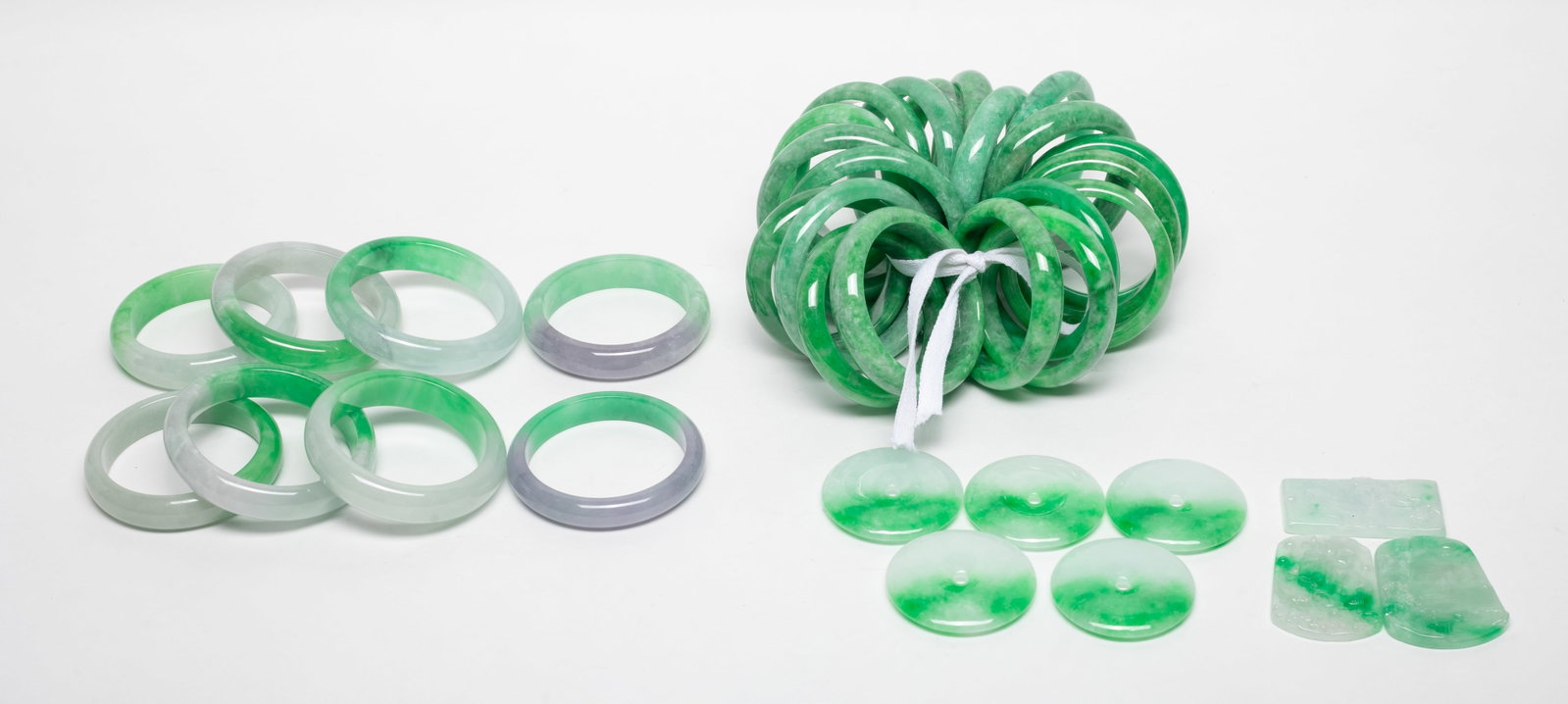 Set Chinese Export Colored Stone Bangles, Pendants: Large set of Chinese colored stone bangles, disc pendants, and plaque pendants carved with landscape or lotus& fish. Size varies.