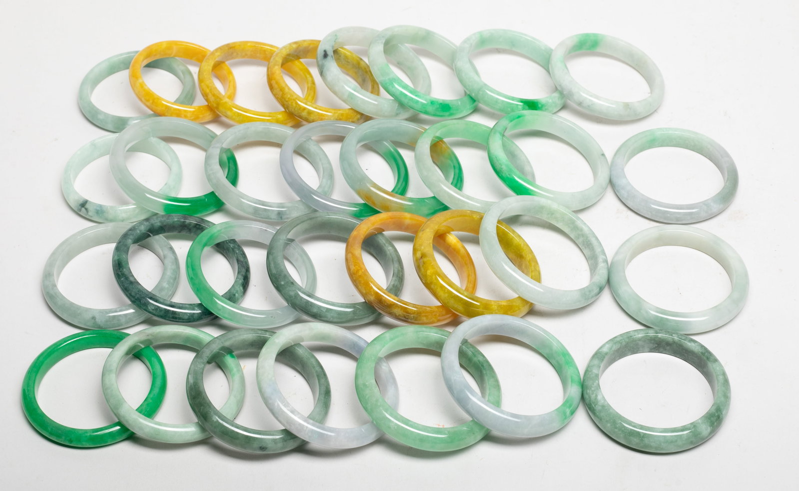 Set Chinese Export Colored Stone Bangles: A large collection of Chinese colored stone bangles. Size varies.