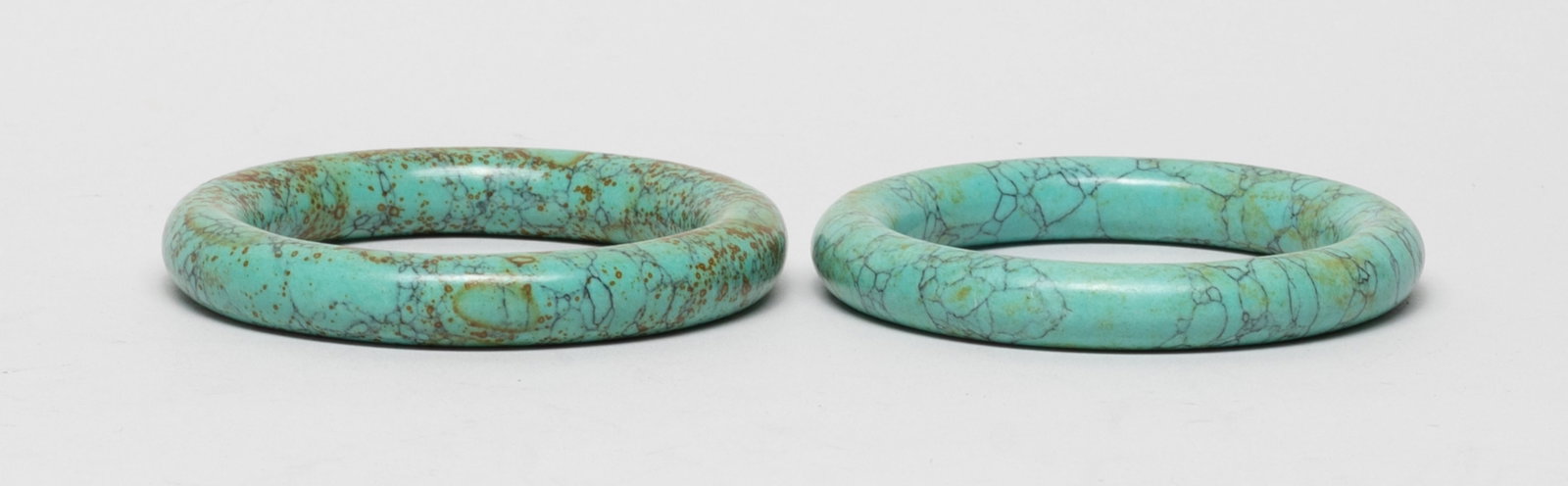 Two Chinese Export Stone Carved Bangles: Two Chinese export stone carved bangles. Approx. 3.3 inch outer diameter, 2.38 inch inner diameter (larger bangle). The Estate of the Store Closed Sale. Downtown. Los Angeles. 2021.
