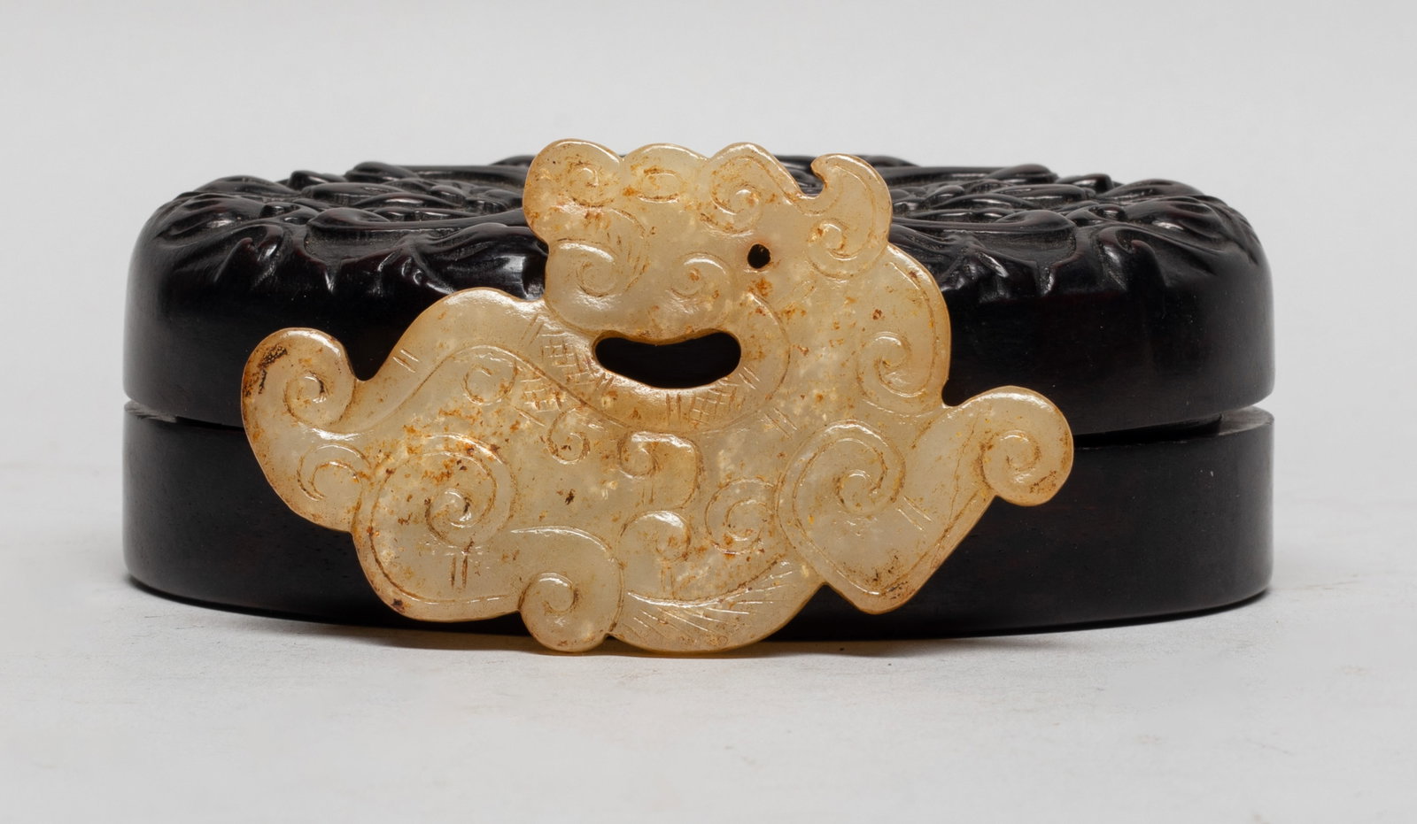 Estate Chinese Russet Jade w/ Box: The russet jade pendant carved as an archaistic beast, its head turned backwards, drilled at the neck for suspension, with a wood box carved with flowers and shou character. Approx. 3.1*1.9 inch