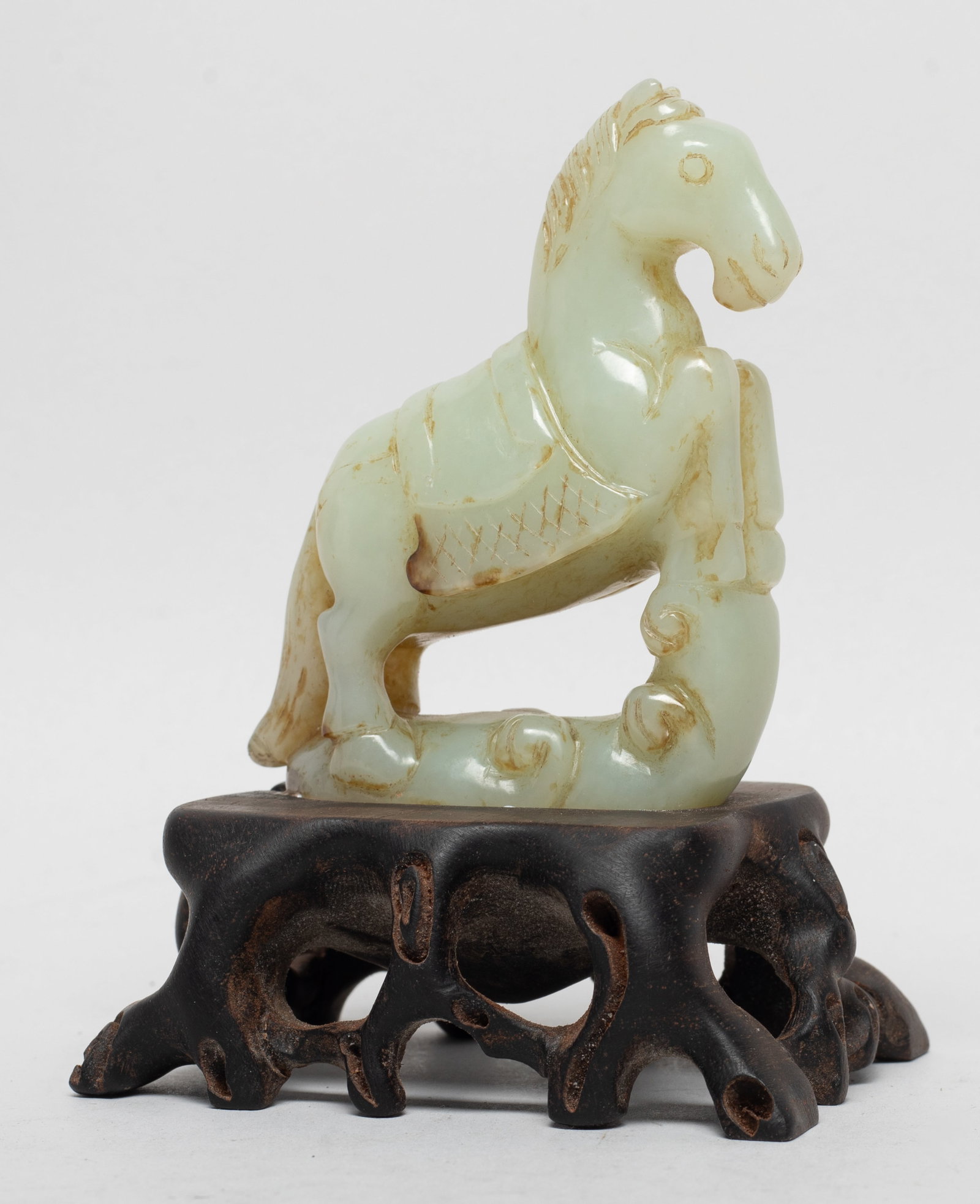Chinese Jade Carved Horse on Wood Stand: Chinese jade carved horse with front legs lifting up and stepping on clouds, affixed to a wood stand. Approx. 4.5*3.2*2.7 inch (w/ stand).