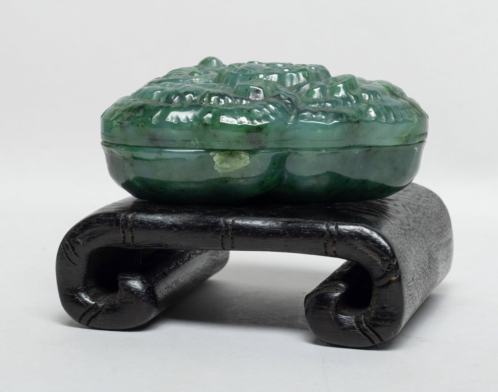 Chinese Spinach Jade Box w/ Wood Base: Naturalistically carved as a three wrinkled ruyi heads, with a beast recumbent at the centre, with stand. Approx. 3.6*2.6*1.5 inch (w/o stand). The Estate of the Heritage of D. C. Chang. Downtown LA. 