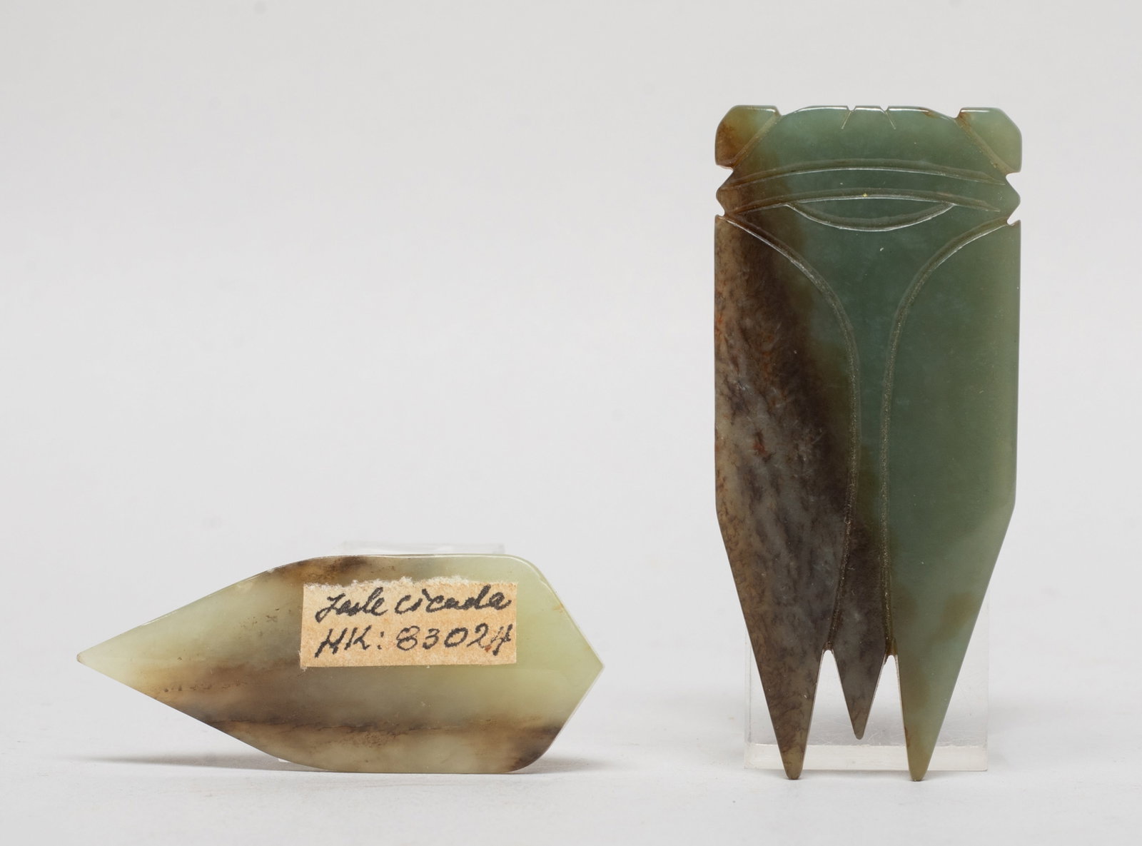 Two Chinese Russet Jade Cicada Pendants: Two russet jade pendants carved of stylized cicada form. Approx. 2.57*1.17 inch (larger). The Estate of the Joseph & Family. Pasadena. CA. 2020.