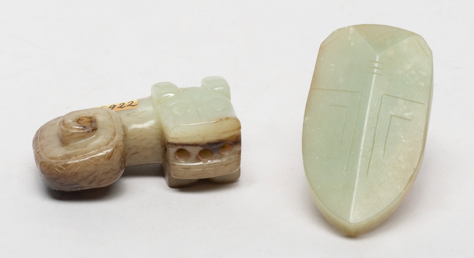 Two Chinese Export Jade Pendants: One carved of archaistic cicada form, the other worked of stylized beast form, the beast head turned to the right, the coiled body forming an aperture. Approx. 2.2*1.2*0.9 inch (larger). The Estate of