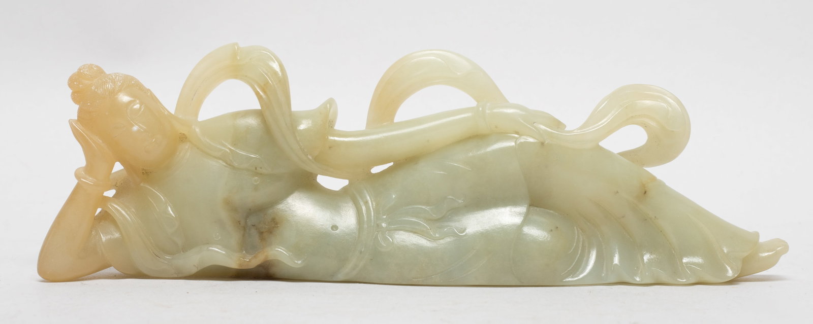 Estate Chinese Russet Jade Sculpture of Buddha: The Buddha carved elegantly lying on her right side, dressed in a long curled scarf and a dhoti. Approx. 7.7*2.4*1.15 inch.