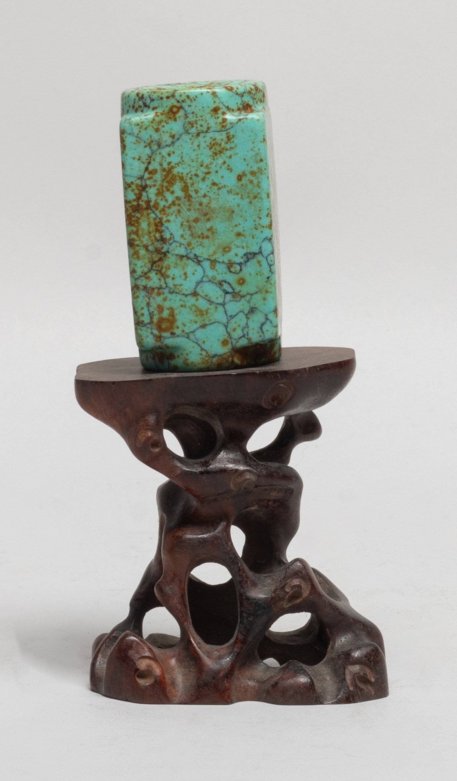 Chinese Stone Carved Cong w/ Wood Base: Of square cross section surrounding a central circular tube with rounded square collars, with a tall wood stand reticulated of gnarled branch form. Approx. 2.55*1.35*1.35 inch (w/o stand). The Estate