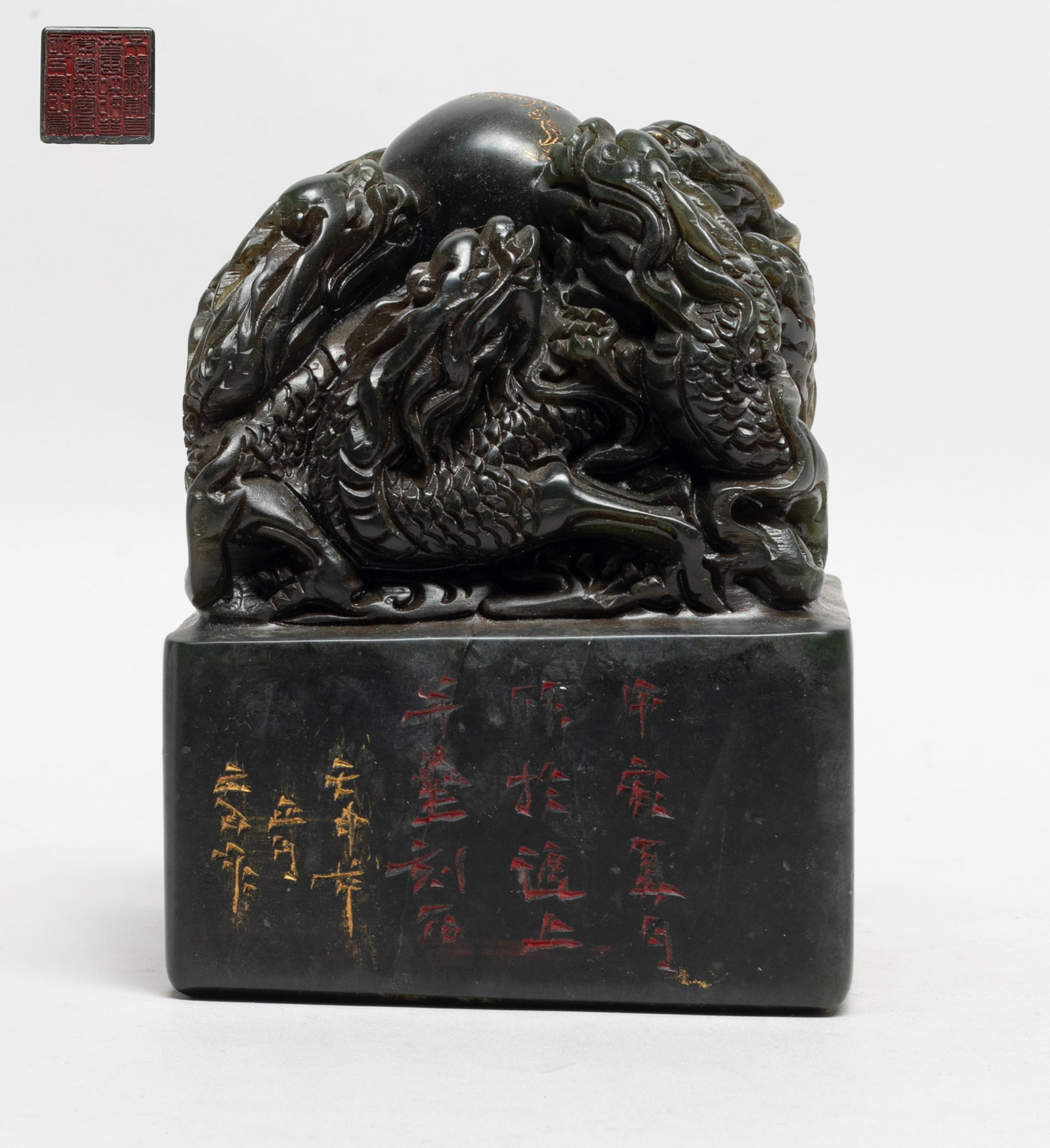 Chinese Stone Dragon Seal: Heavy stone seal of square section, carved on the top with nine intertwined dragons pursuing a ball among clouds, the seal sides incised with flowers. Approx. 4.05*3.95*5.4 inch.