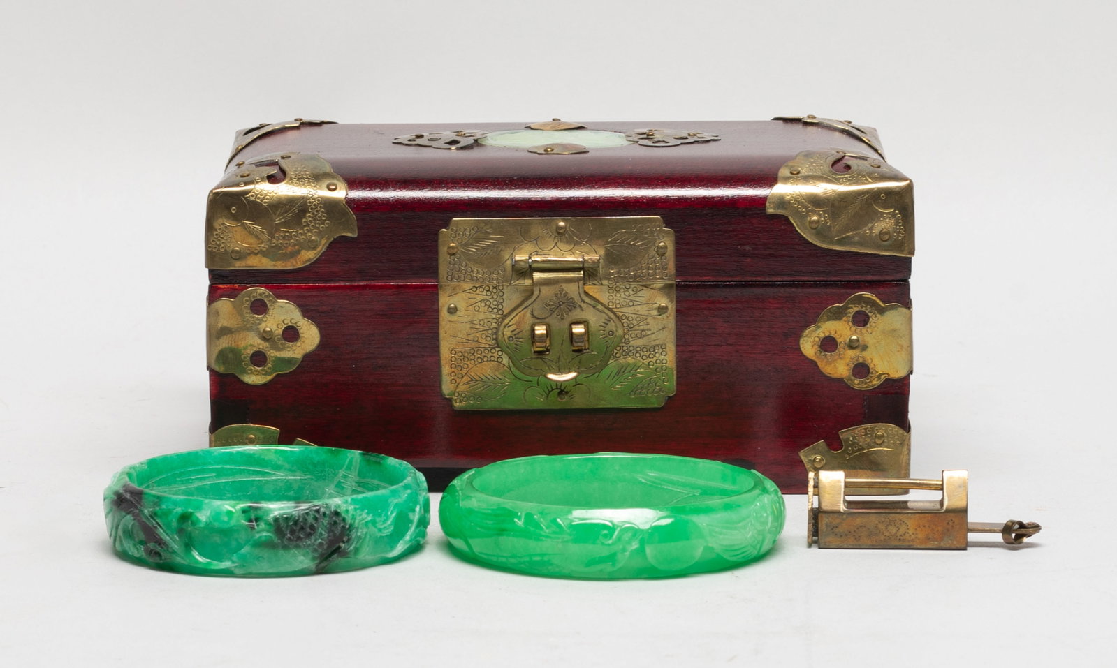 Two Chinese Export Colored Stone Bangles: One bangle carved with a dragon and a phoenix pursuing a ball, the other bangle carved with fish, lotus, bird and lingzhi, with a jewelry box inset with a stone plaque on the top. Approx. 3.07 inch