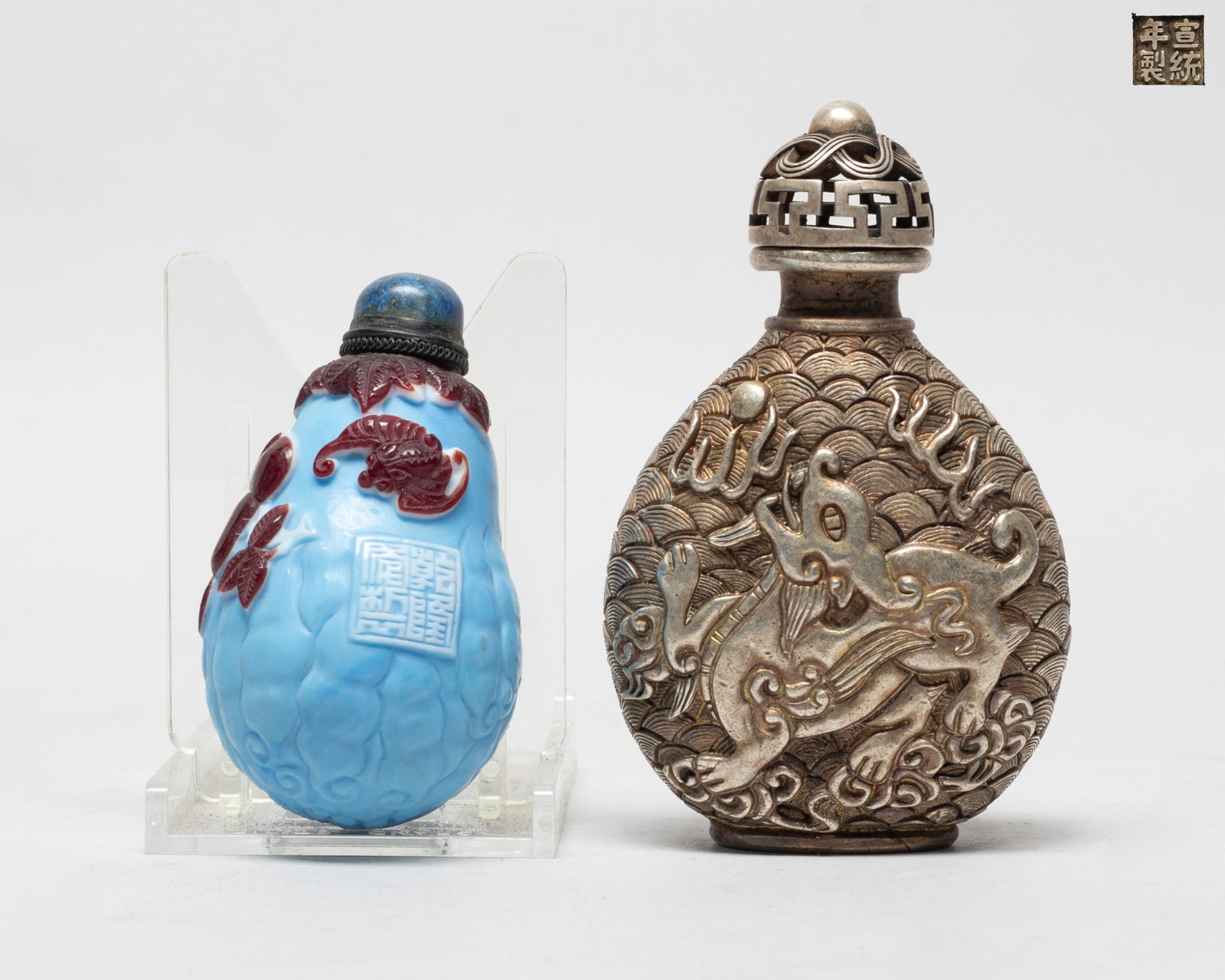 Two Chinese Export Snuff Bottles: One of flattened ovoid form, either side carved with a beast over waves, the bottom with a four-character mark, the other glass snuff bottle of buddha hand citron form, carved with peaches and bats,