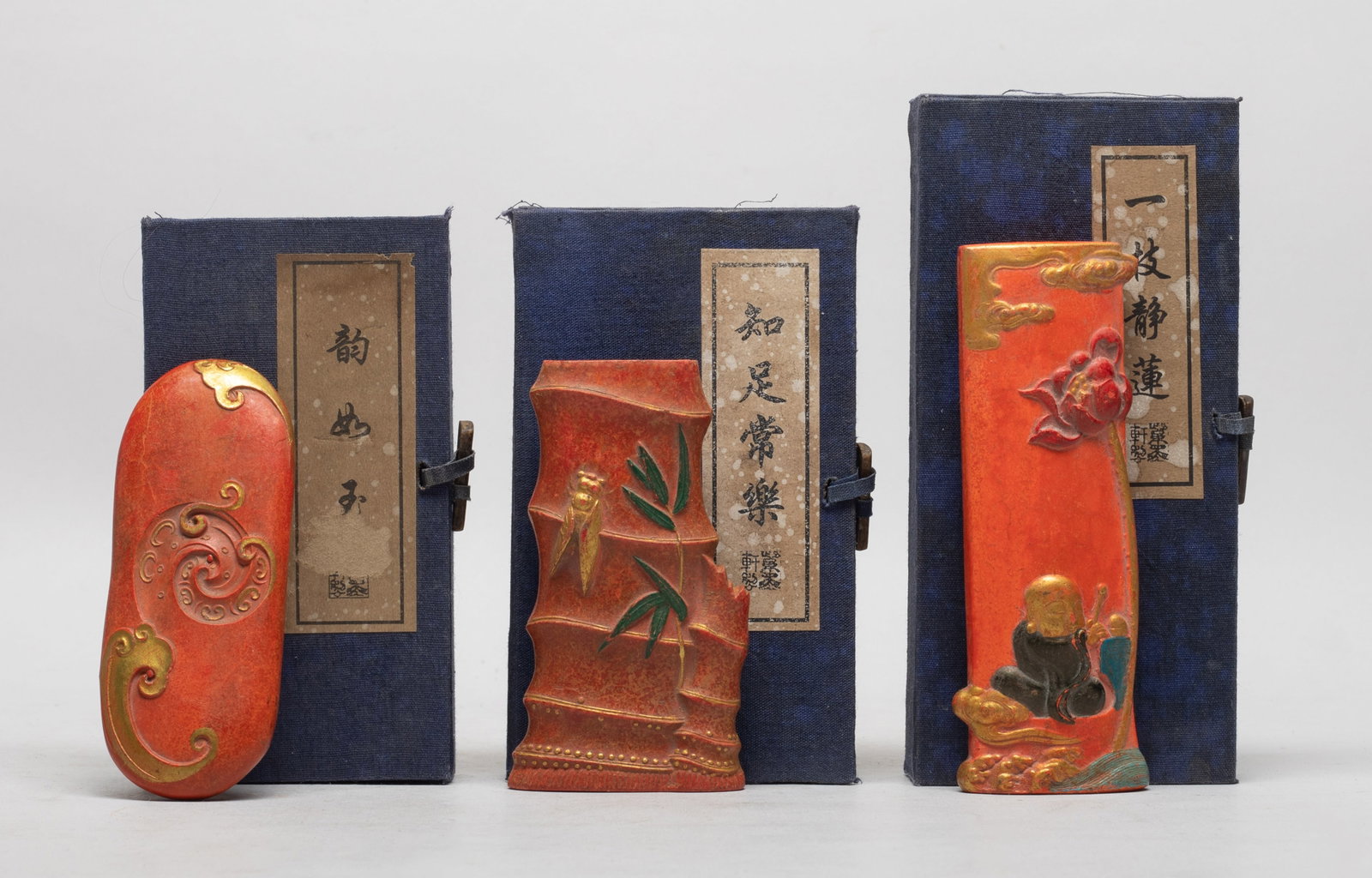 Three Estate Chinese Ink Sticks: Set of three Chinese ink sticks with boxes, one carved bamboo and cicada, one carved clouds, the other carved Buddha and lotus. Approx. 5.05*1.8*0.8 inch (largest ink).
