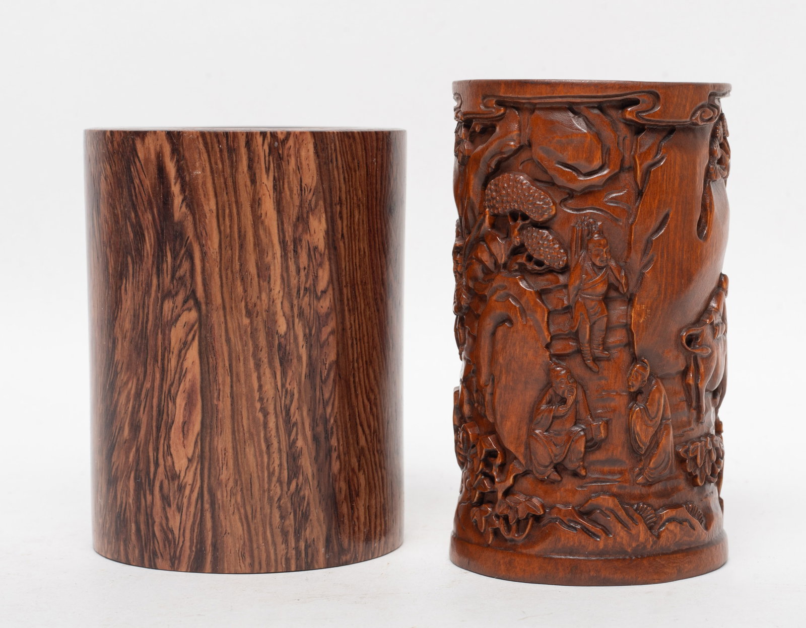 Estate Two Chinese Wood Brush Pots: Two wood brush pots of cylindrical form, wherein one exterior carved with figures in various activities in landscape setting. Approx. 3.5*2.65 inch (larger).