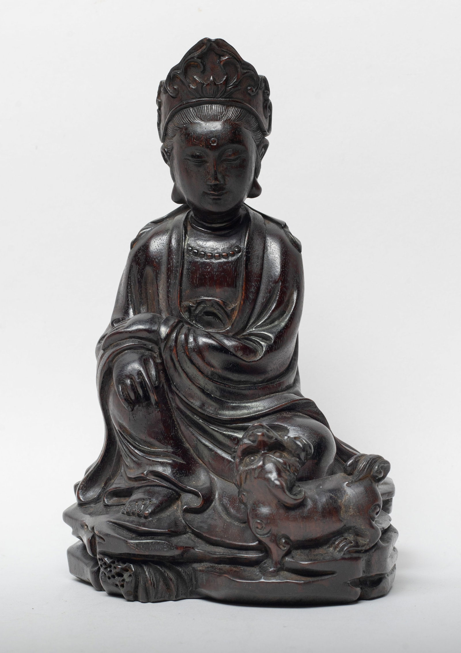 Chinese Zitan Wood Carved Sculpture of Buddha: The Buddha carved seated in regal repose, with a beast around his left leg, wearing a loose-fitting robe, the rounded face surmounted with a diadema framing a high chignon. Approx. 7*4.4*3.9 inch,