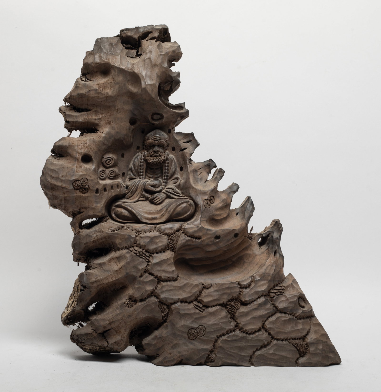 Large Chinese Agarwood Sculpture: Carved with Buddha seated among craggy rockery, the hands holding a bowl. Approx. 1250 gram, 12*10.5*2.4 inch.