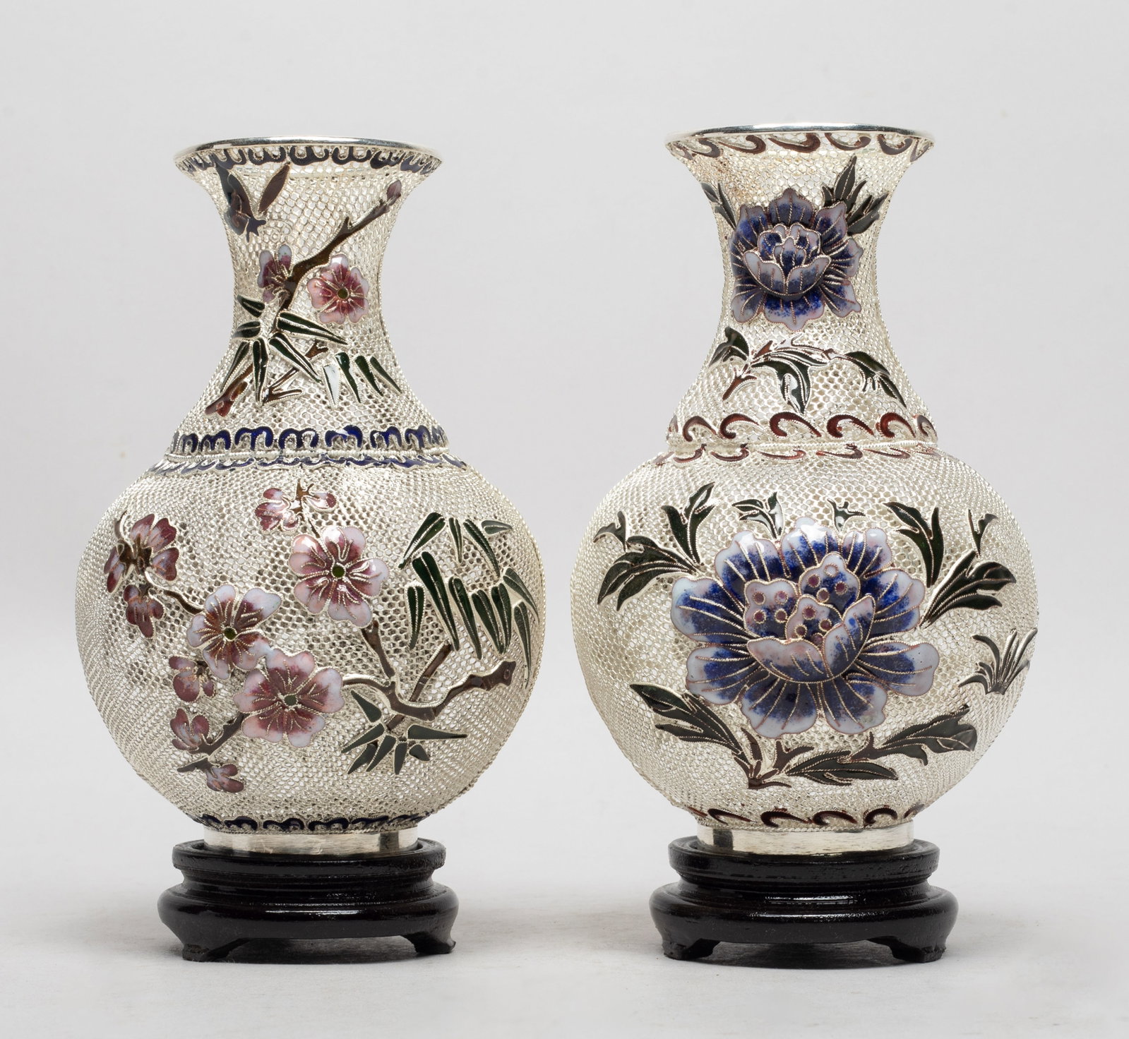 Two Vtg. Chinese Enameled on Silver Vases: Two reticulated silver vases, enameled with blossoming peony in blue, white, brown and dark green colors, with stands. Approx. 3.7*5.9 inch (each).
