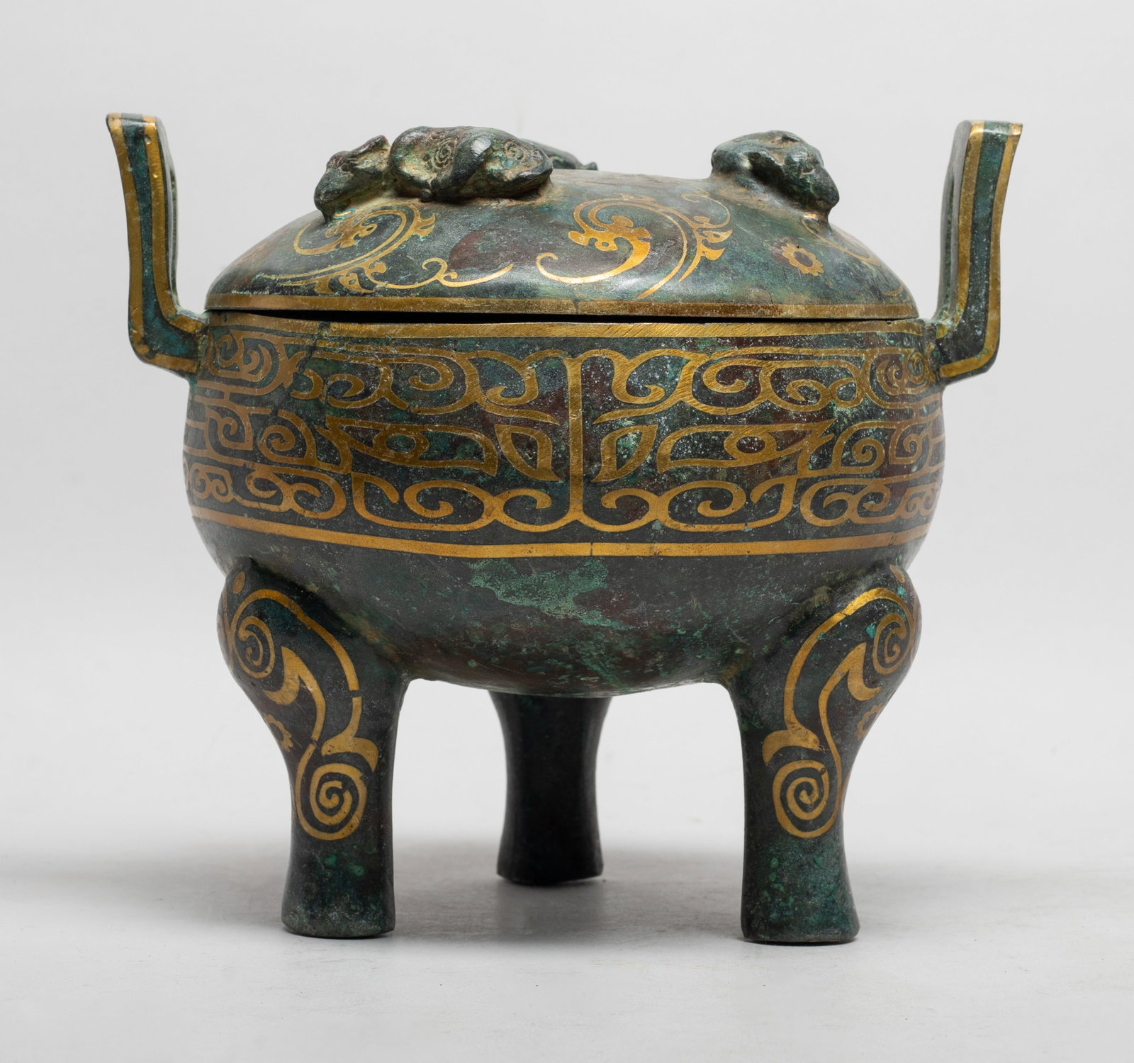 Estate Chinese Bronze Covered Censer: Of compressed globular form, with three legs and two handles, the lid cast with three recumbent beasts, the body and lid exterior decorated with archaistic motif. Approx. 7.7*6.8*6.5 inch.
