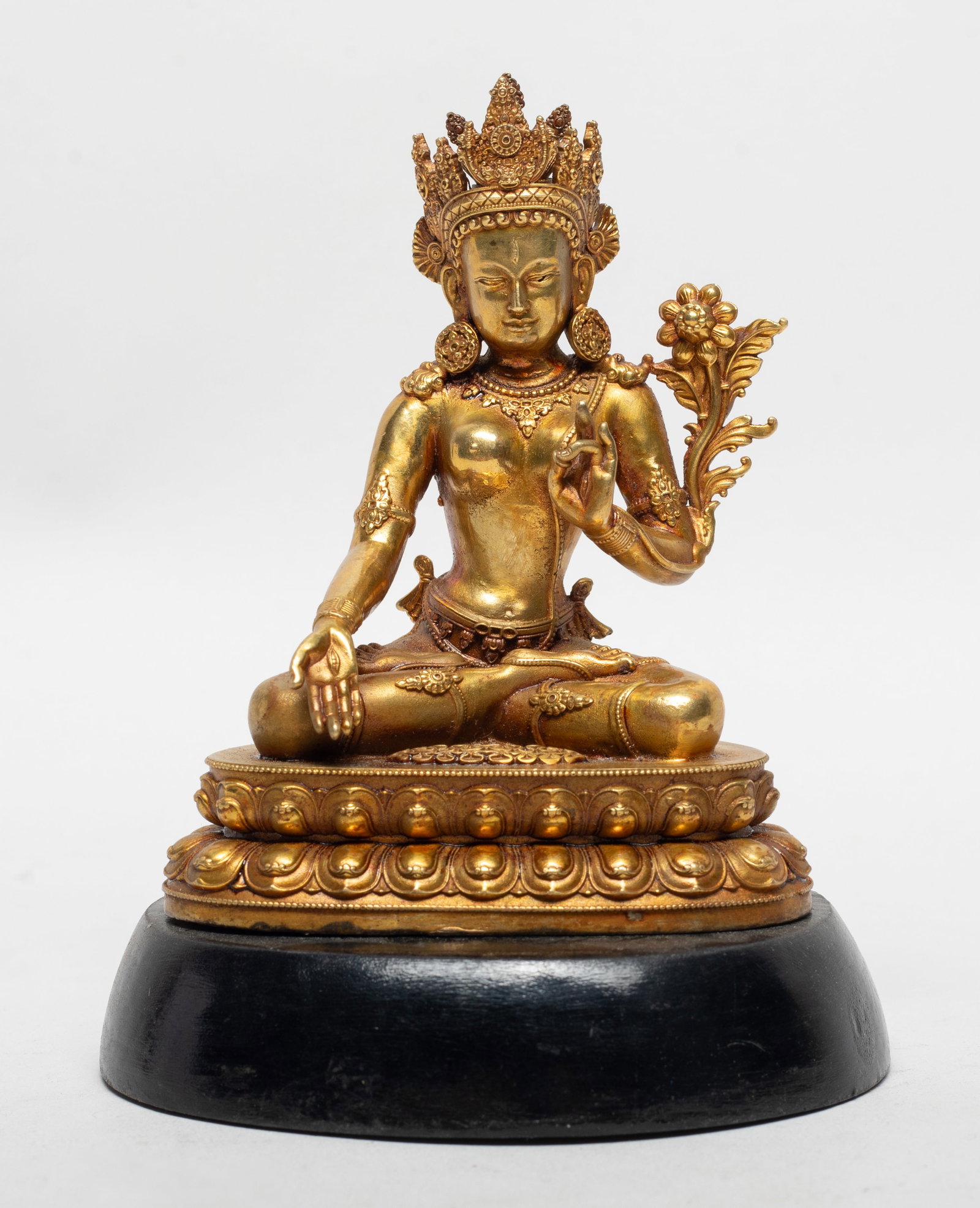 Chinese Gold on Bronze Buddha w/ Base: The Buddha cast seated on a waisted lotus base, the hands in elegant mudra incised with eyes on the palms, wearing delicate diadema and jewelry, with stand. Approx. 3.9*3.07*2.37 inch (w/o stand).