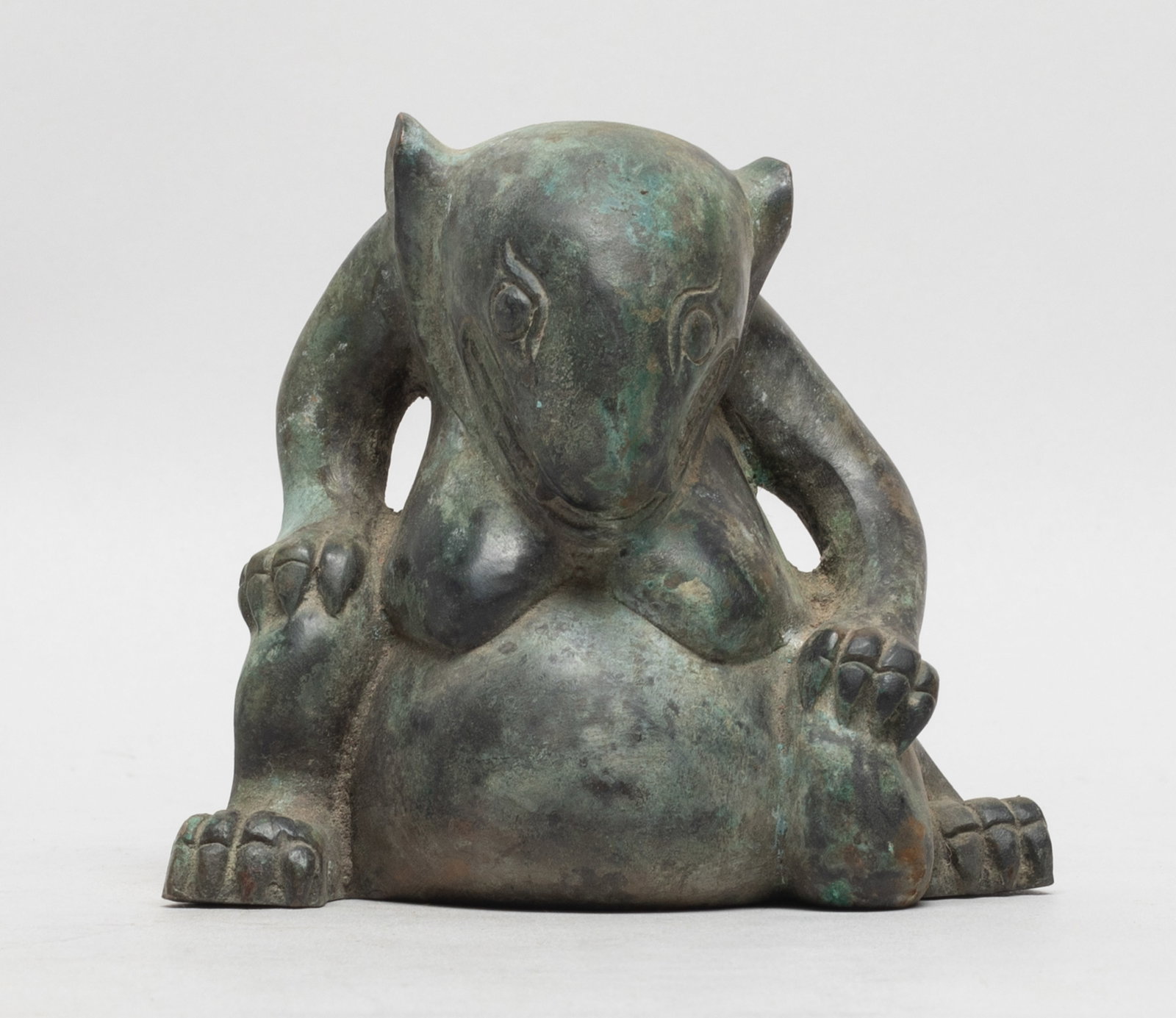 Estate Chinese Bronze Table Sculpture: Moulded as a seated mythical beast, the mouth agape baring its teeth and fang. Approx. 3.9*4.4*2.7 inch.