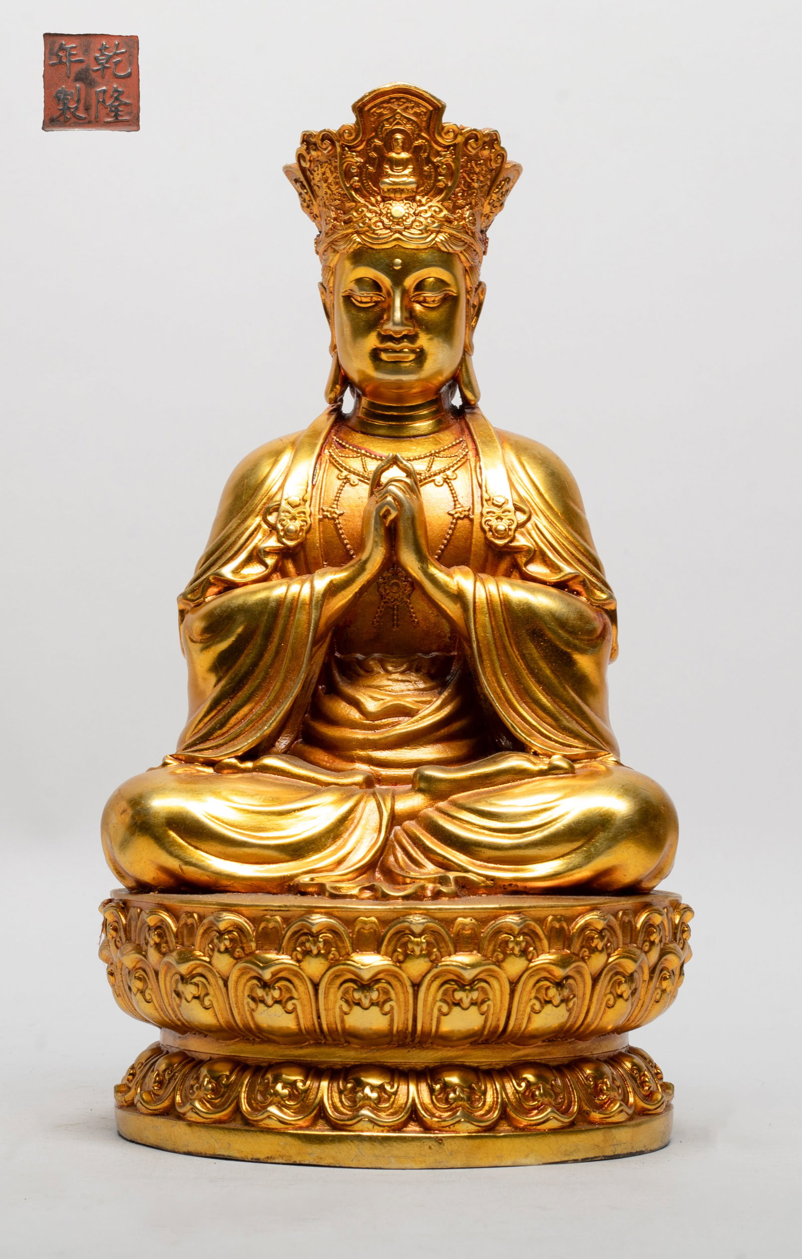 Vtg. Chinese Gold on Bronze Buddha: The Buddha cast seated on a waisted lotus base, wearing a long flowing robe and a delicate diadema, thee hands in uttarabodhi mudra, the bottom inscribed with a four-character mark. Approx. 9.6*5.2*5