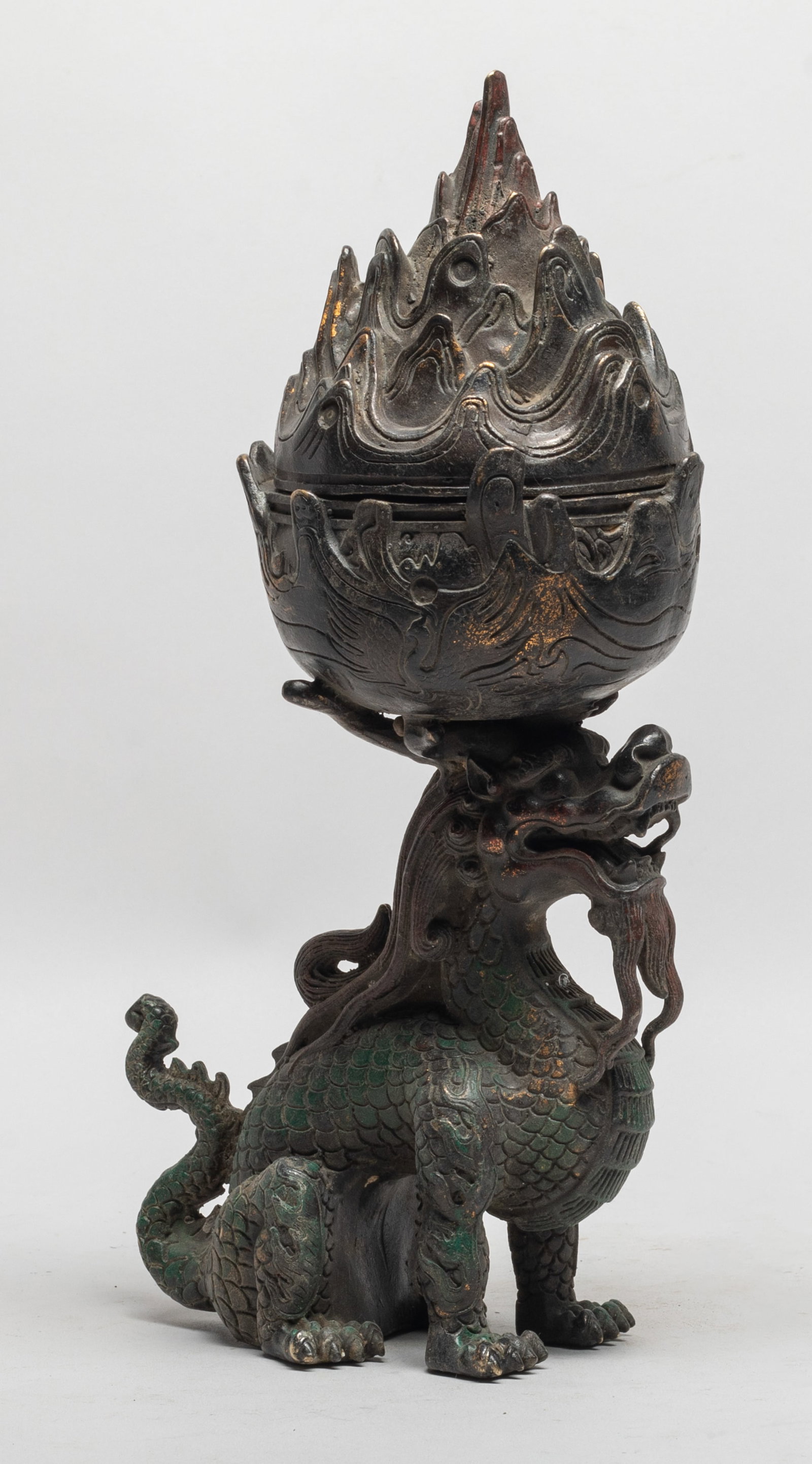 Unusual Chinese Bronze Beast Censer: The censer comprising a pierced cover cast as a pierced mountain-peaks range, supported on a beast's head, the scaly beast in crouching pose, his face fully defined with bulging eyes, large nose and o