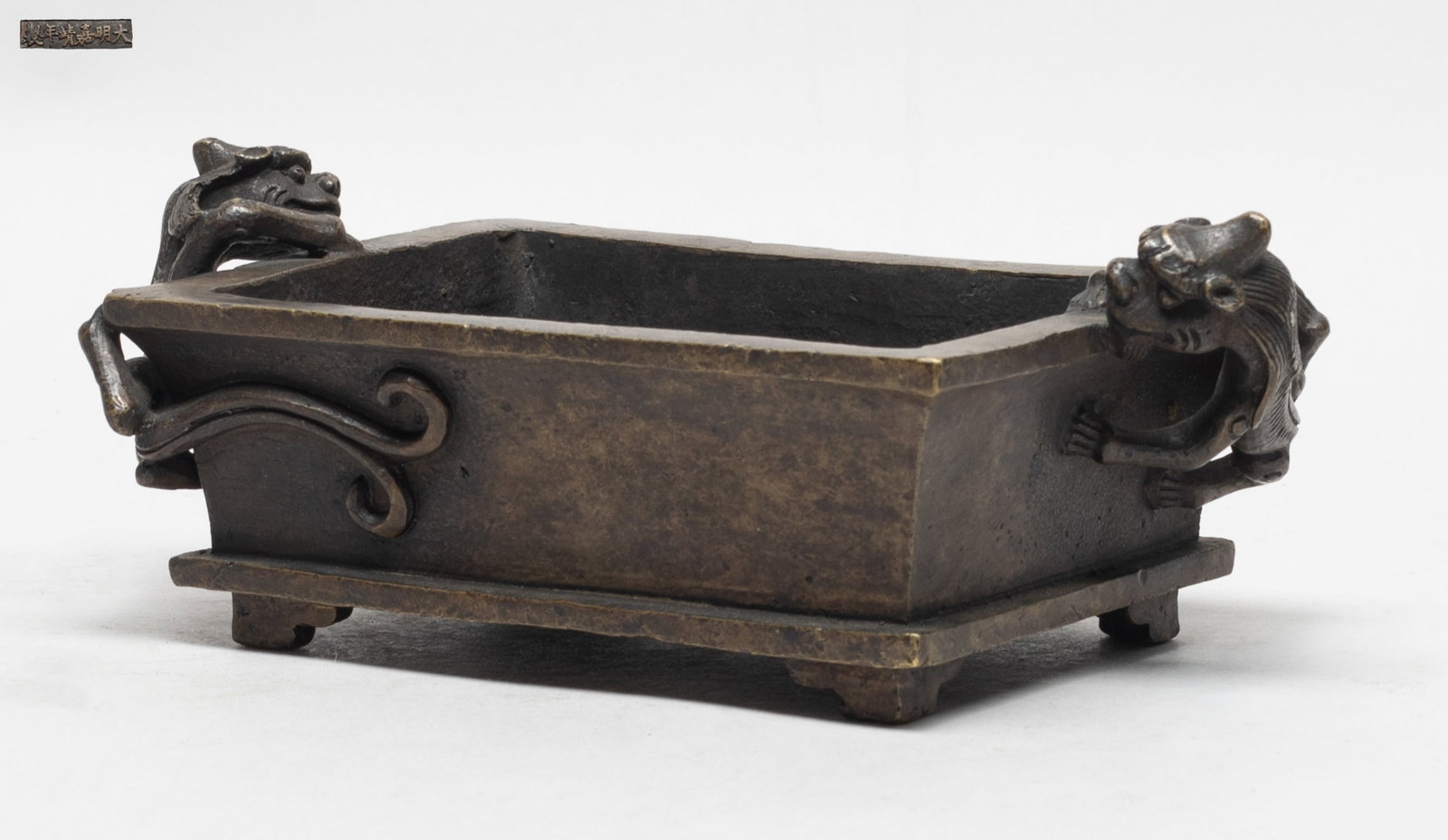 Estate Chinese Bronze Cabinet Censer: Of tapered rectangular section, flanked with two beasts clambering on the narrow sides, the bottom marked with six characters. Approx. 7.3*4.1*2.7 inch.