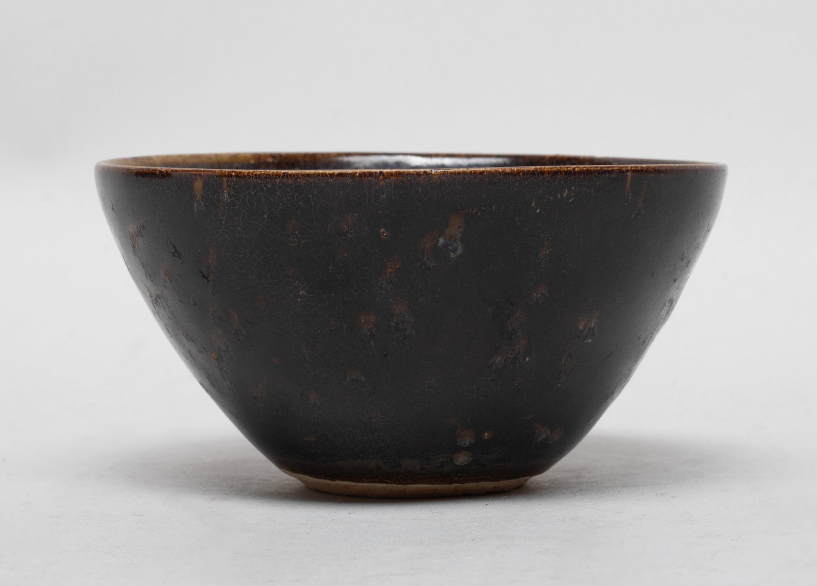 Chinese Shipwreck Type Jizhou Porcelain Bowl: The bowl inside and out covered with crackled black glaze, the interior decorated with imprints of flowers revealing veins. Approx. 4.5*2.3 inch.