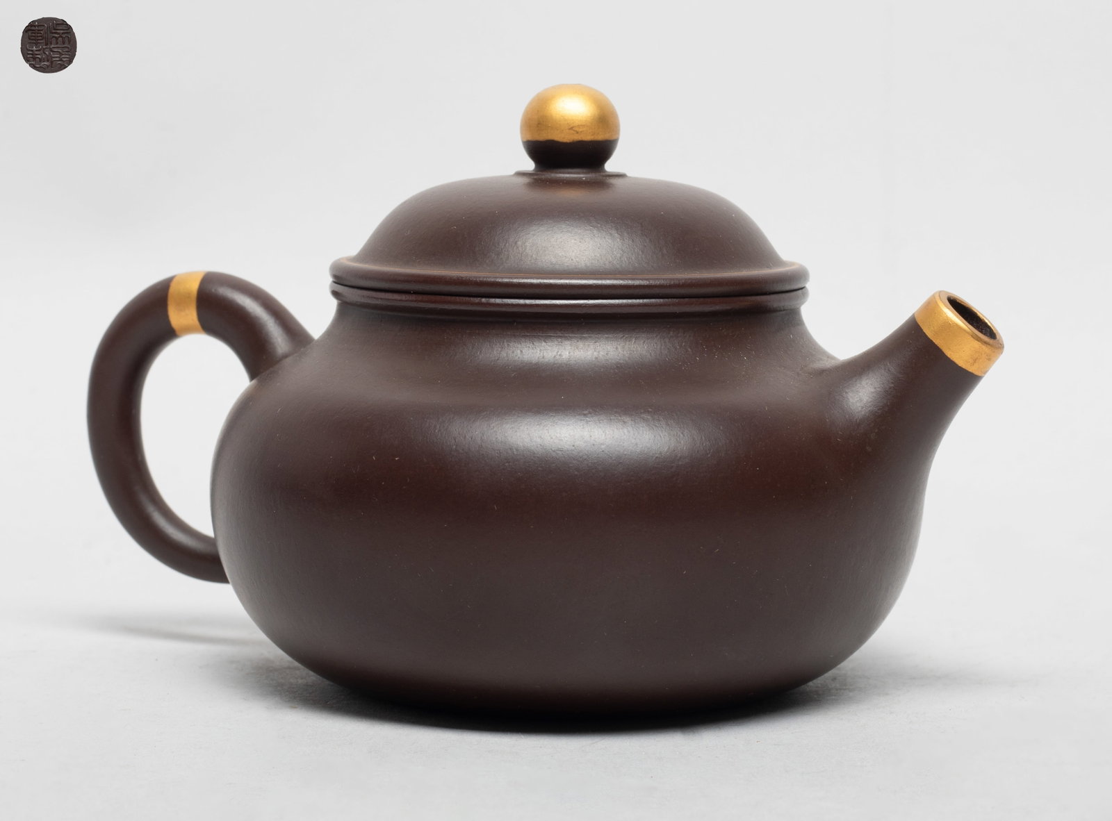 Chinese Gilt Yixing Zisha Tea Pot: Of compressed globular form, the lid interior incised with two marks and the pot bottom with a circular mark. Approx. 5.6*4*3.5 inch.