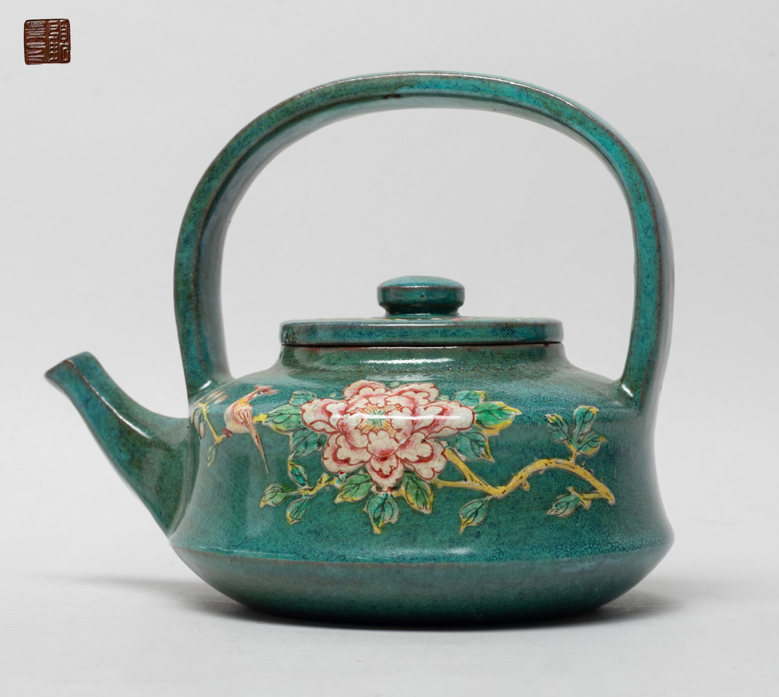 Chinese Export Yixing Zisha Tea Pot: The tea pot enameled and painted with flowers on turquoise glazed ground suffused dark blue bubble motif, the lid interior with two marks and the pot bottom with a seal mark. Approx. 4.8*5.9*4.6 inch.