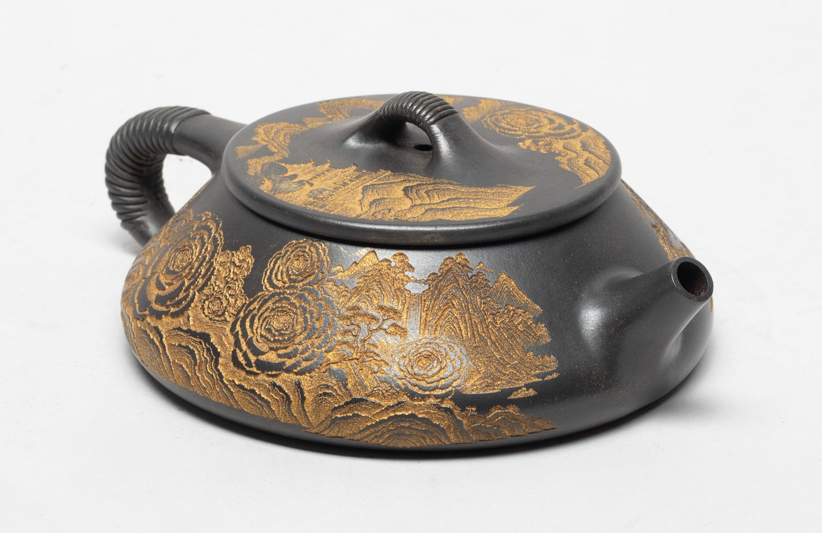 Chinese Gild Painted Zisha Tea Pot: The tea pot body incised and gilded with landscape, the bottom with peony, the lid interior with two marks. Approx. 6.1*4.7*2.1 inch.
