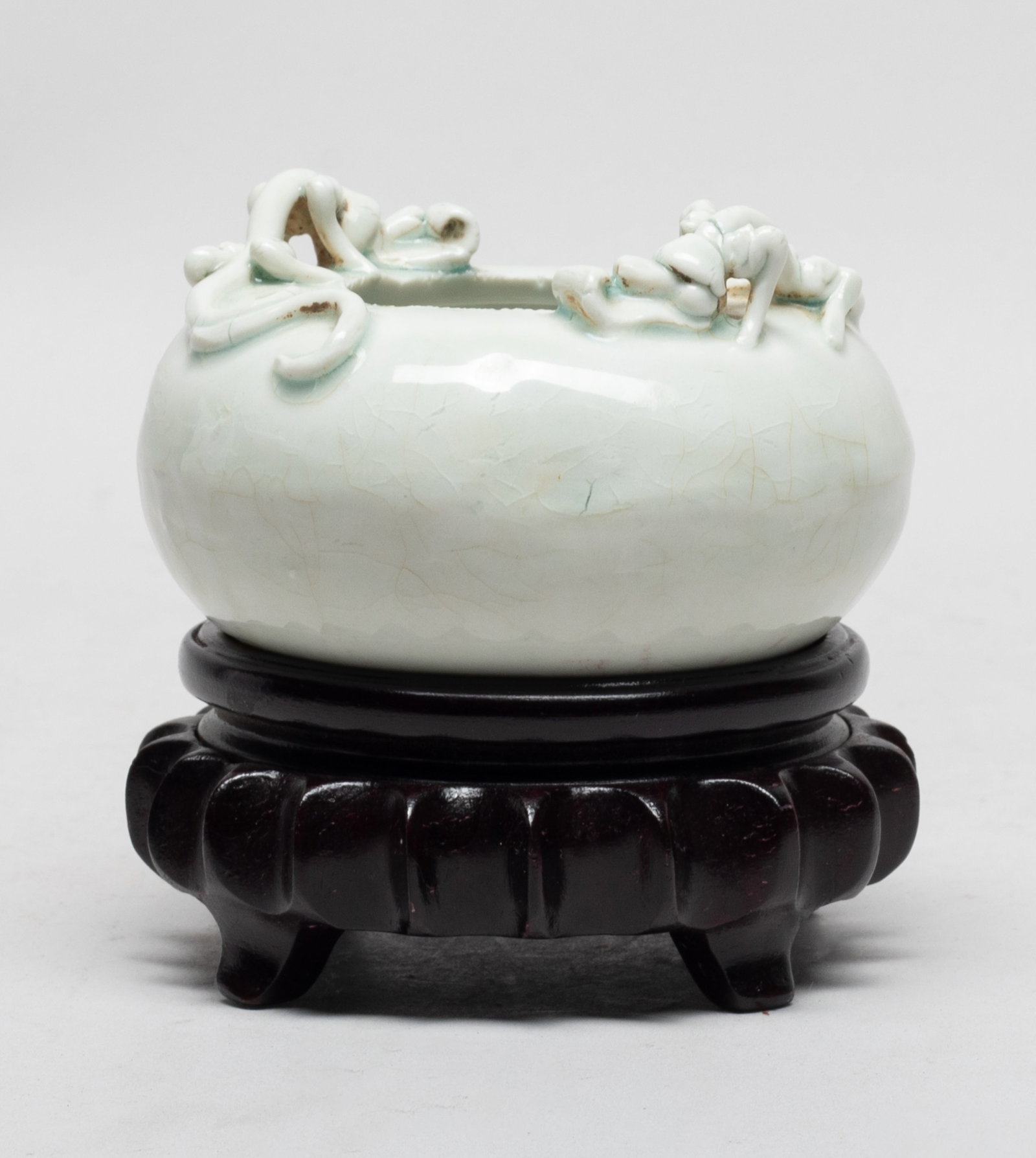 Chinese Export Blanc De Porcelain Washer: Of compressed form, carved in high relief with two sinuous dragons around the mouth, covered in crackled bluish white glaze, with stand. Approx. 3.8*2.4 inch (w/o stand).