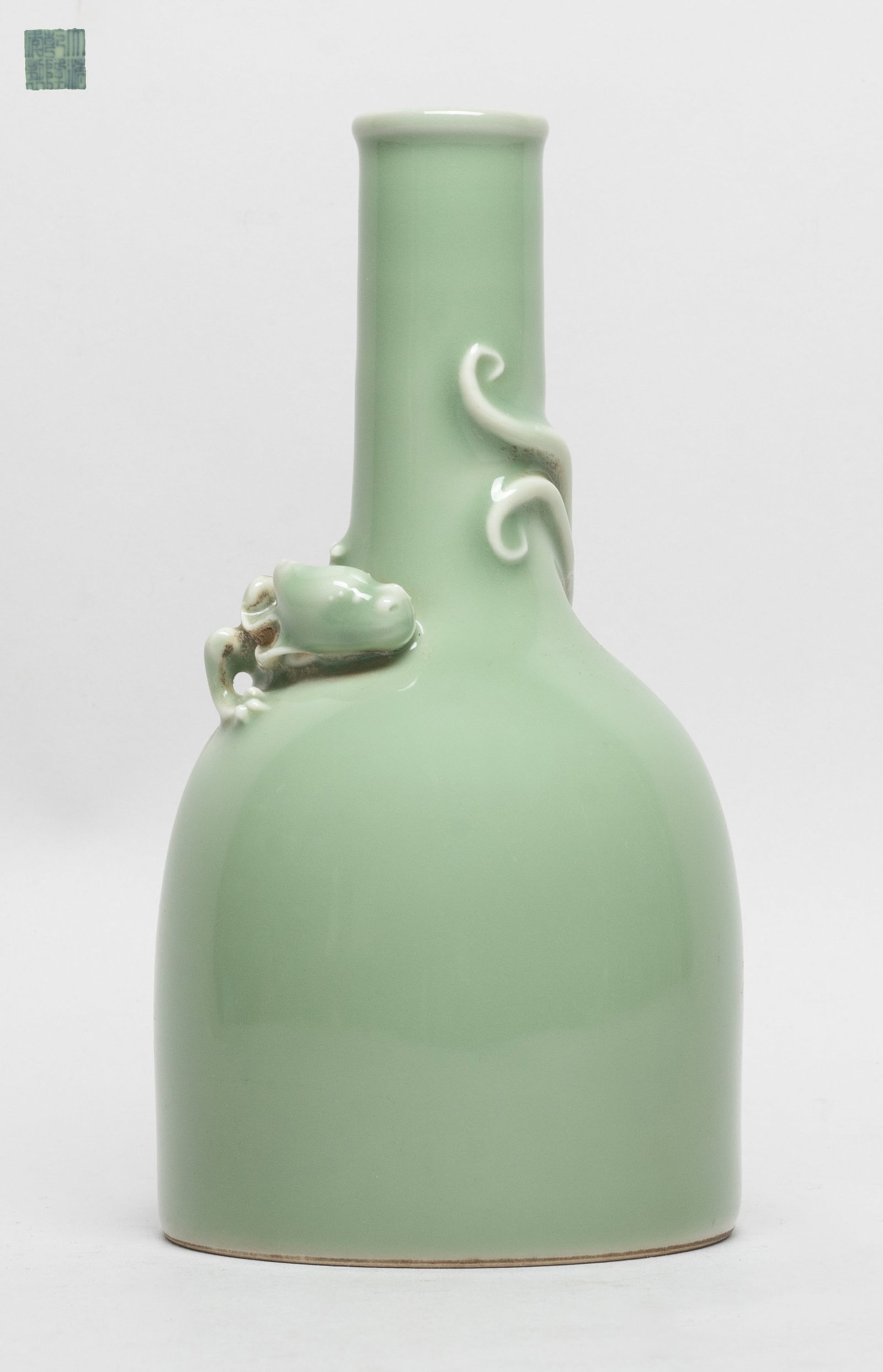 Chinese Bean Green Glazed Porcelain Vase: The vase exterior and bottom covered with bean green glaze, carved in high relief with a chi dragon around the tall neck, the bottom with a six-character mark. Approx. 3.7*7 inch.