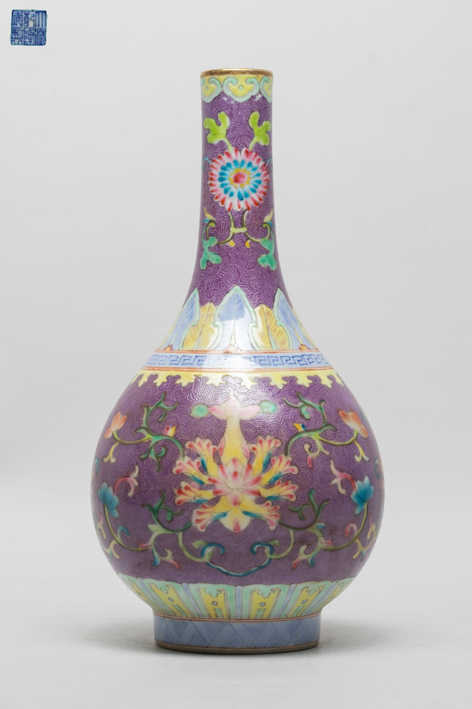 Estate Chinese Enamaled Porcelain Vase: The vase body and neck decorated with lotus sprays, all against purple glazed body suffused with scrolls, the interior and bottom turquoise glazed, with a six-character mark on the bottom. Approx.