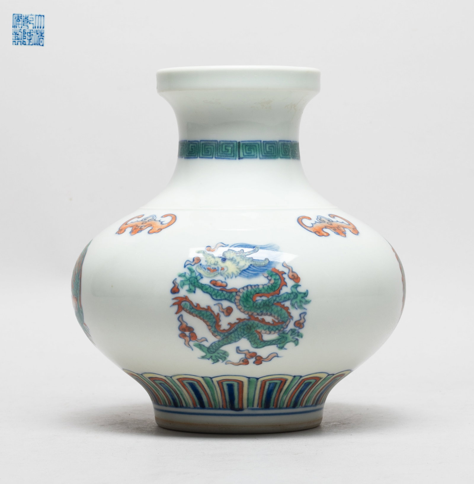 Chinese Export Porcelain Cabinet Vase: The vase exterior painted with dragons and phoenixes forming in circular shape under four bats, above a band of lappets, the bottom with a six-character mark. Approx. 6.1*6.6 inch.