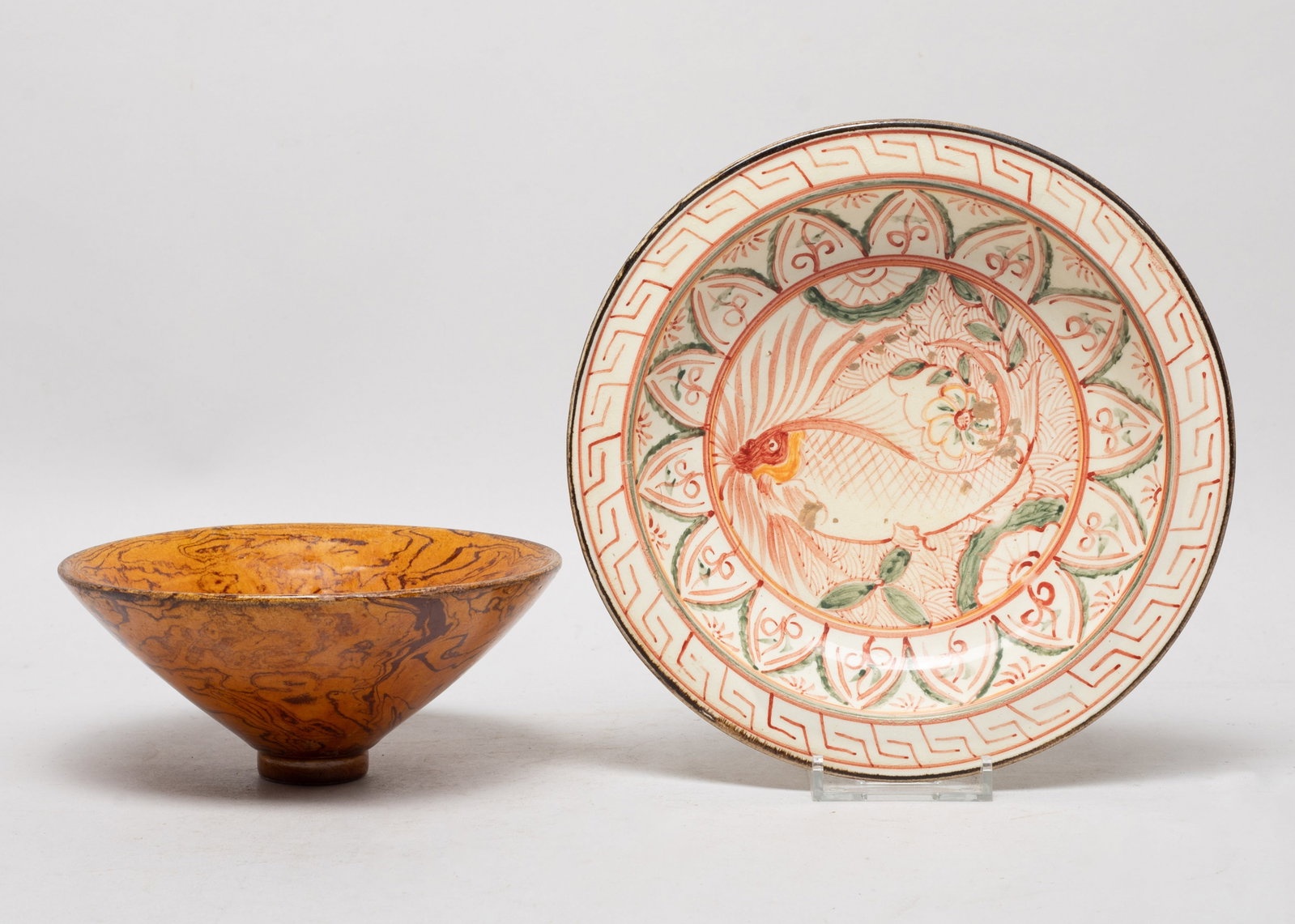 Estate Chinese Export Glazed Porcelain Bowls: One bowl covered in honey brown glaze suffused with grain motif, the other interior painted with a fish among flowers framed by a band of petals. Approx. 7.2*1.7 inch (larger).