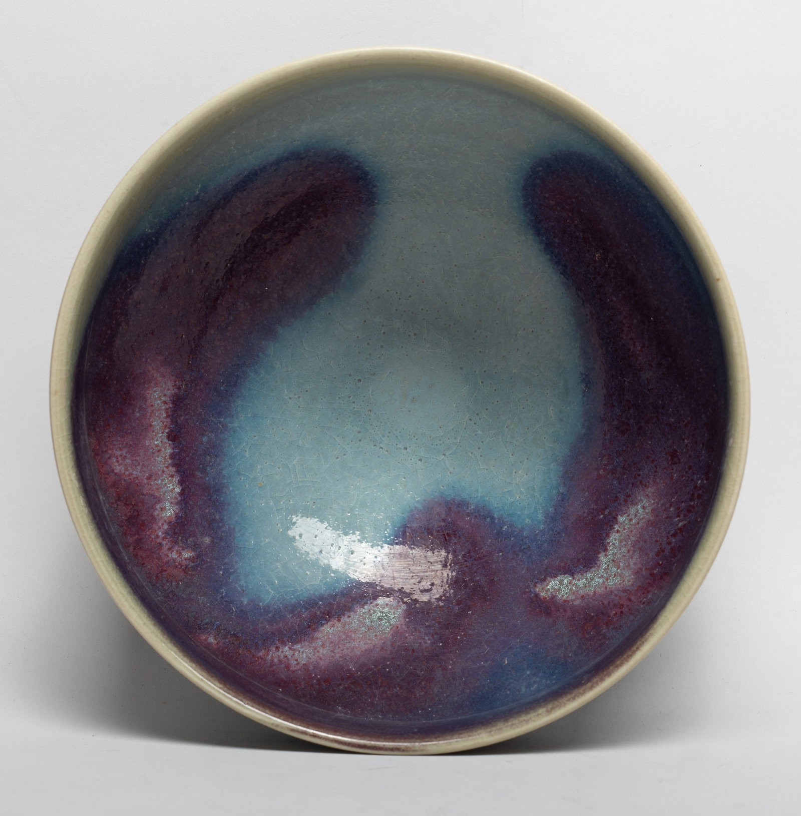 Chinese Export Large Porcelain Bowl: The bowl overall covered in bubbled and crackled milky blue glaze thinning to mushroom tone at the rim with purple splashes. Approx. 7.6*3.6 inch.