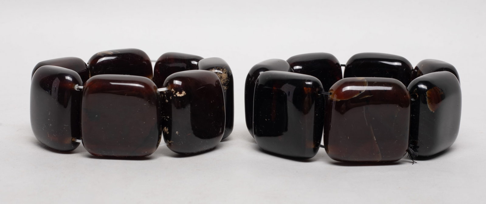 Two Large Slab Bead S Asian Amber Bracelets: Two South Asian amber carved large slab bead bracelets. Approx. 203 gram (total weight). Beads size varies.