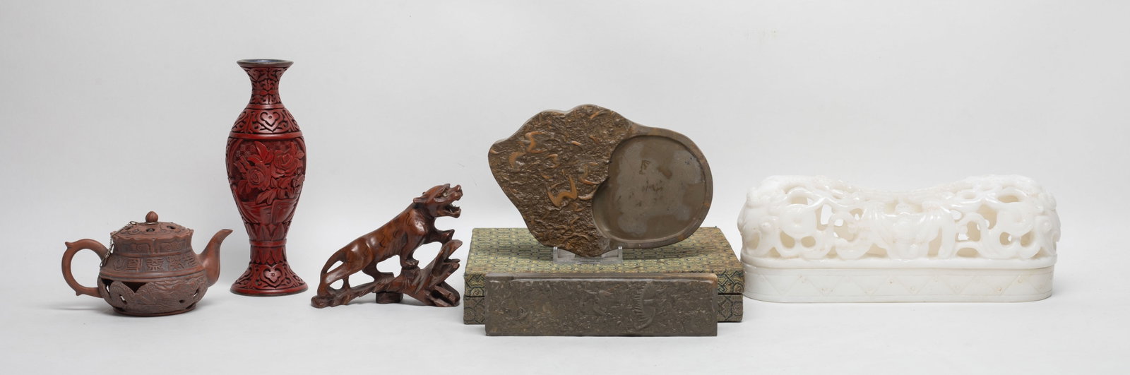 Chinese Ink Stone, Cinnabar, Wood, Decors: Including a pot, a tiger sculpture, a cinnabar vase, a stone openwork case, an ink stone and a paper weight. Approx. 9.4*3.5*3.1 inch (case size).