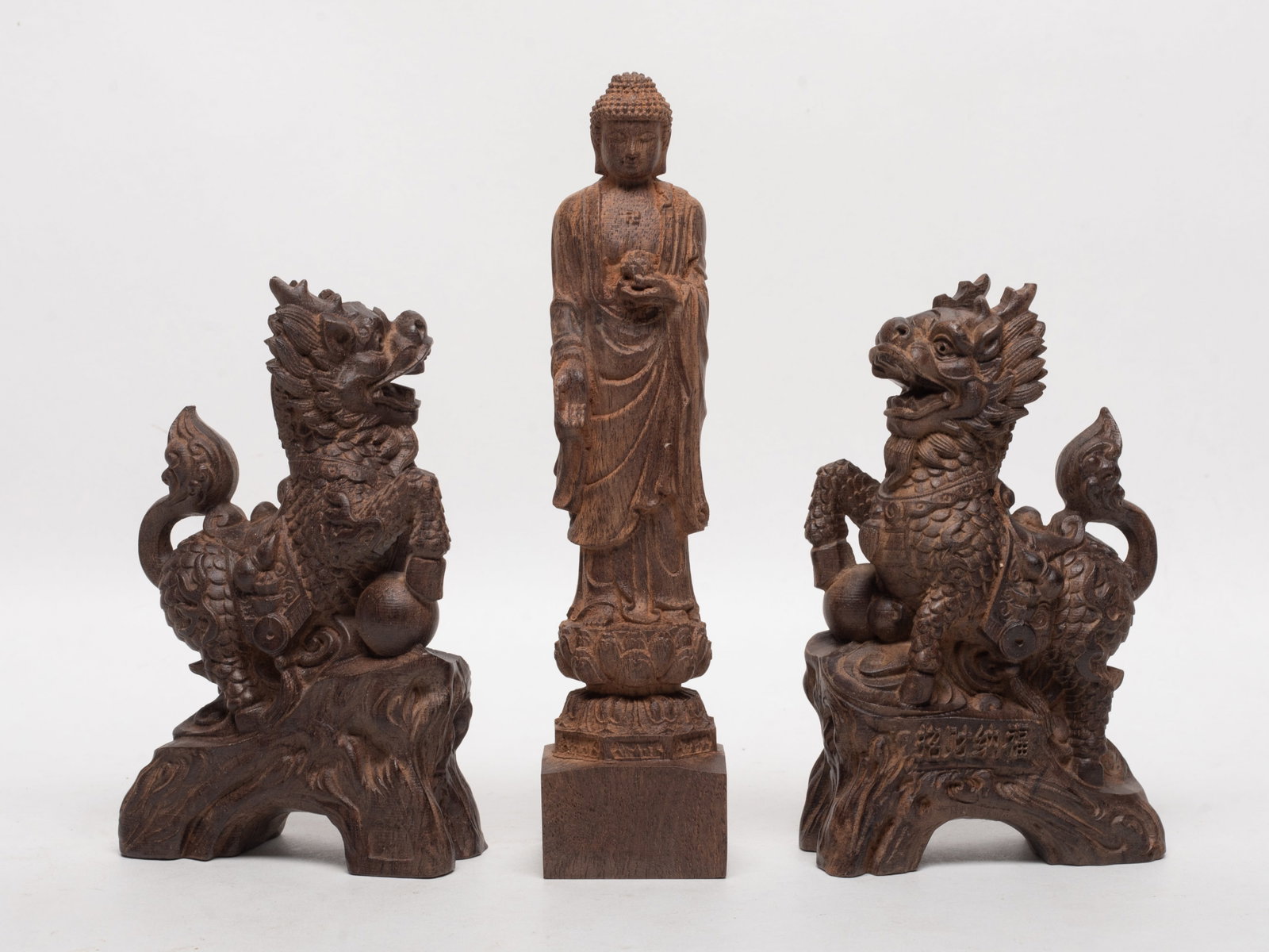 Set South Asian Wood Sculptures: Set of two South Asian wood carved qilin sculptures and a Buddha sculpture. Approx. 695 gram (total weight), 7.3*1.7*1.5 inch (Buddha size).