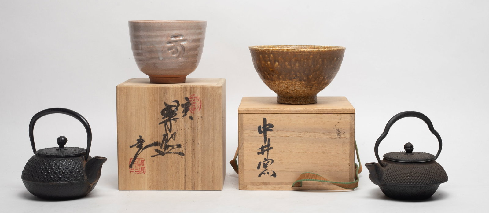 Japanese Old Stoneware, Iron Tea Pots: Including two Japanese stoneware bowls with boxes, and two iron tea pots. Approx. 5*4.7*4.2 inch (larger pot size).
